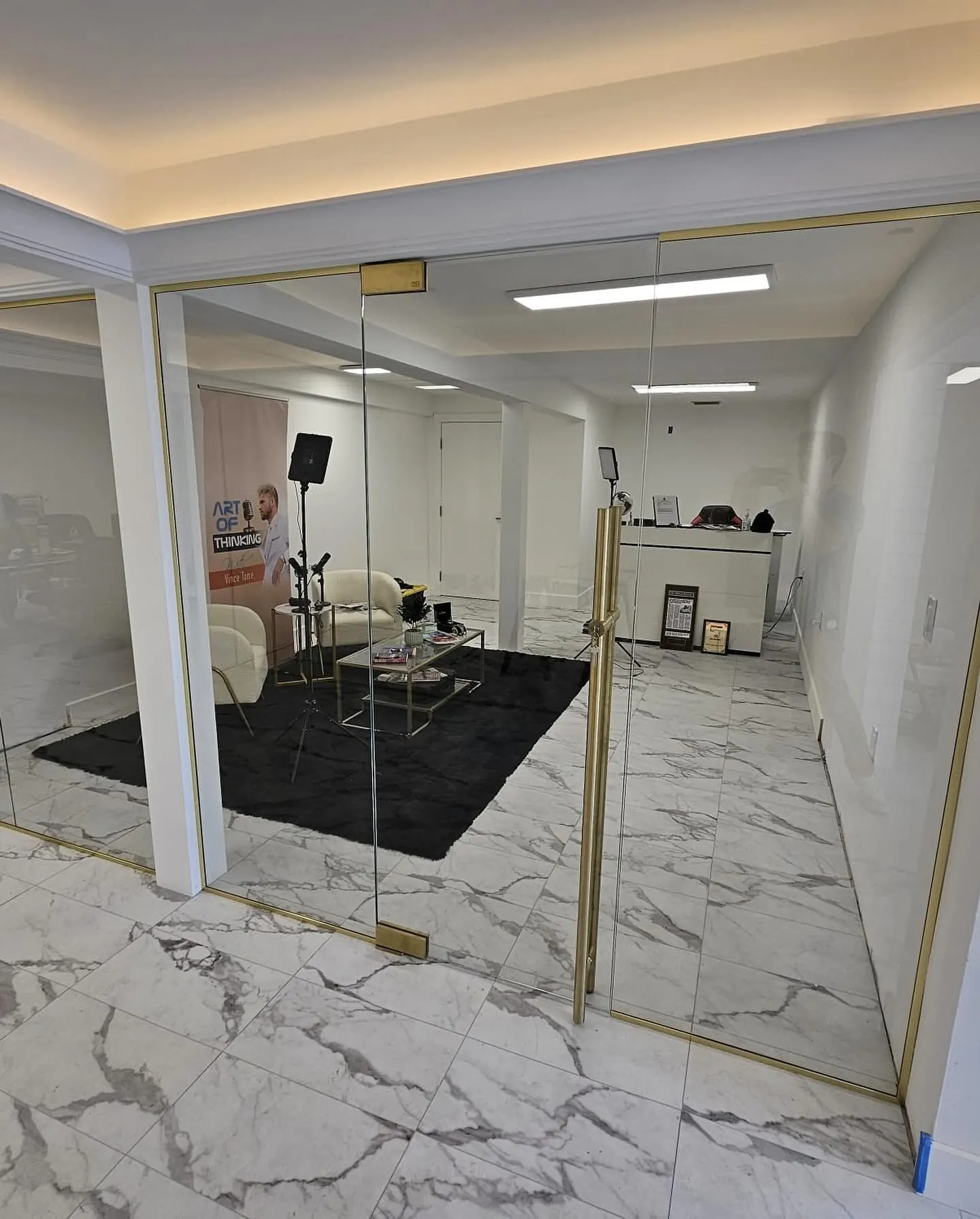 after office glass enclosure with brushed gold hardware in Southwest Florida