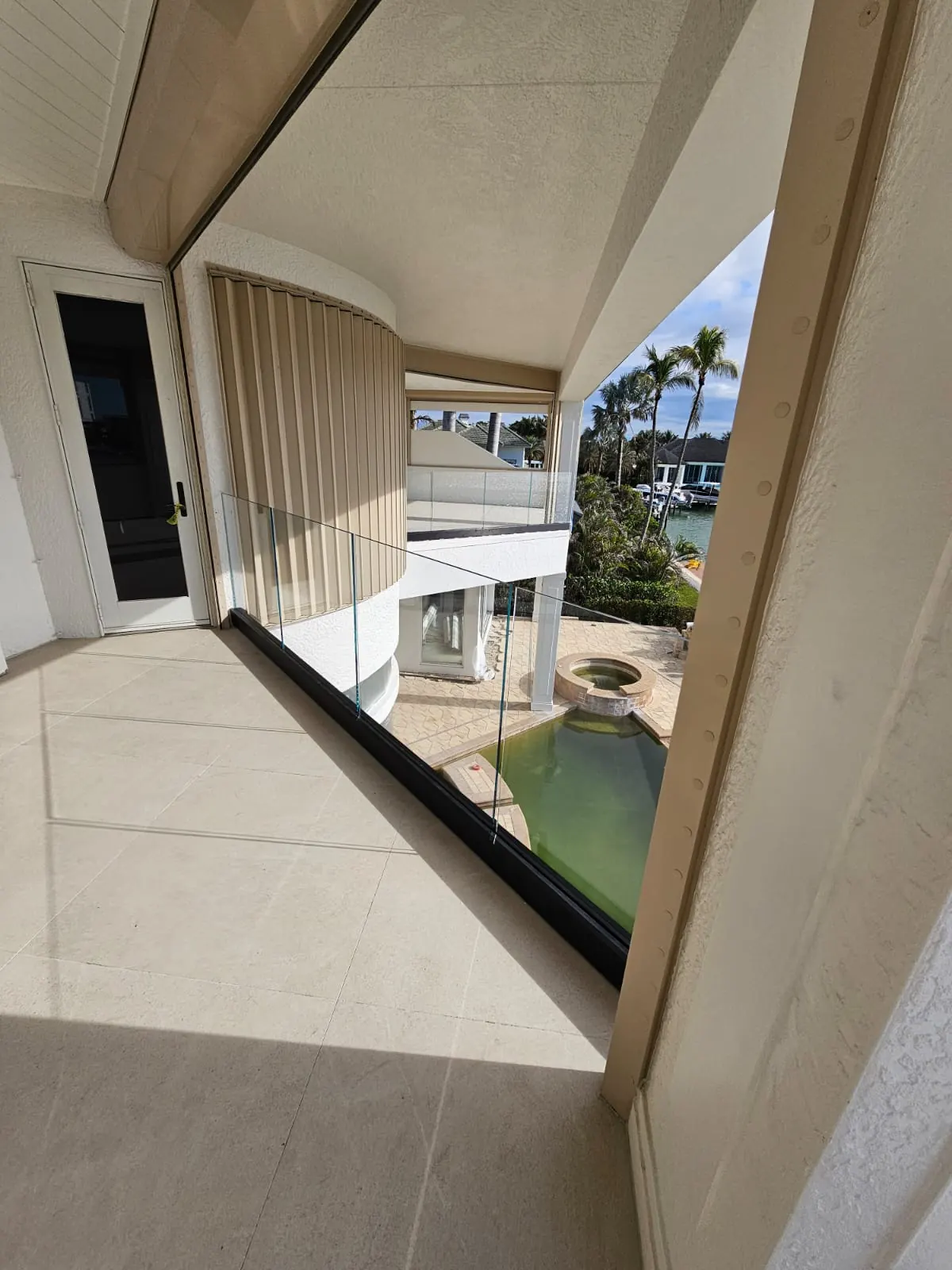 after ultra clear glass railing with black hardware in Southwest Florida