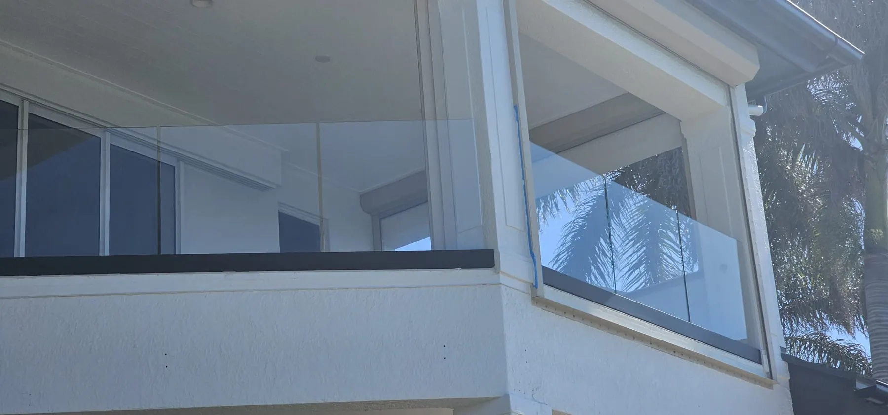 after ultra clear glass railing with black hardware in Southwest Florida