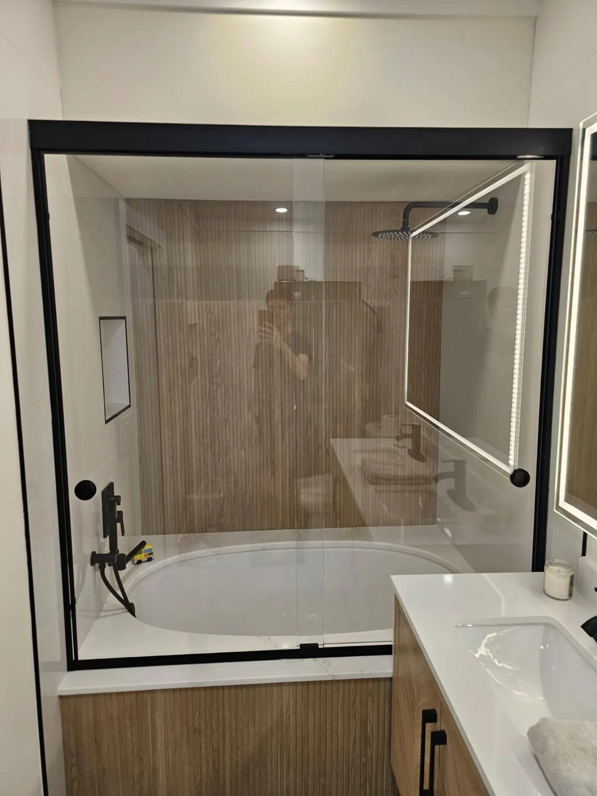 after framed sliding shower glass with black hardware in Southwest Florida