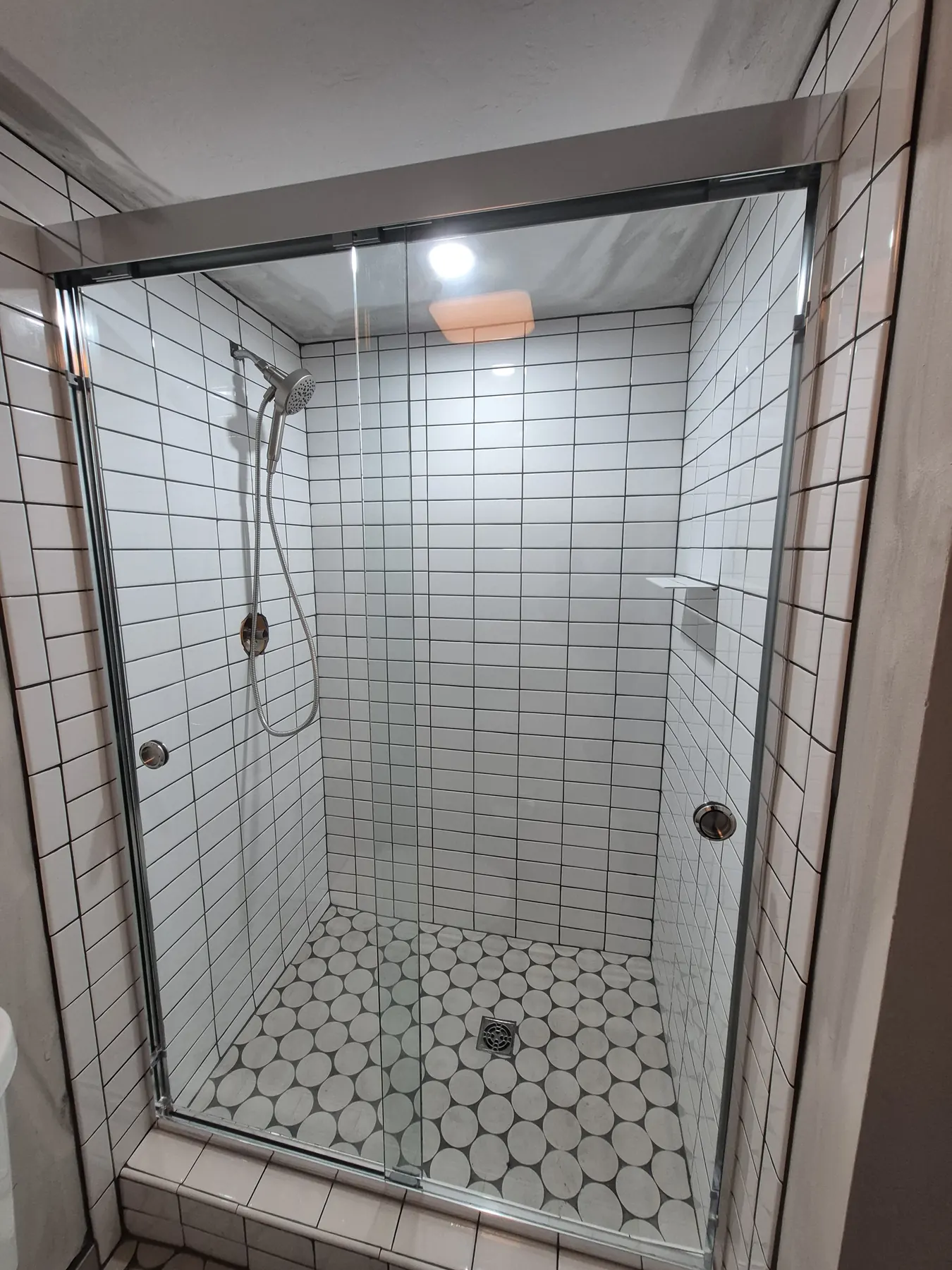 after framed sliding shower glass with chrome hardware in Southwest Florida