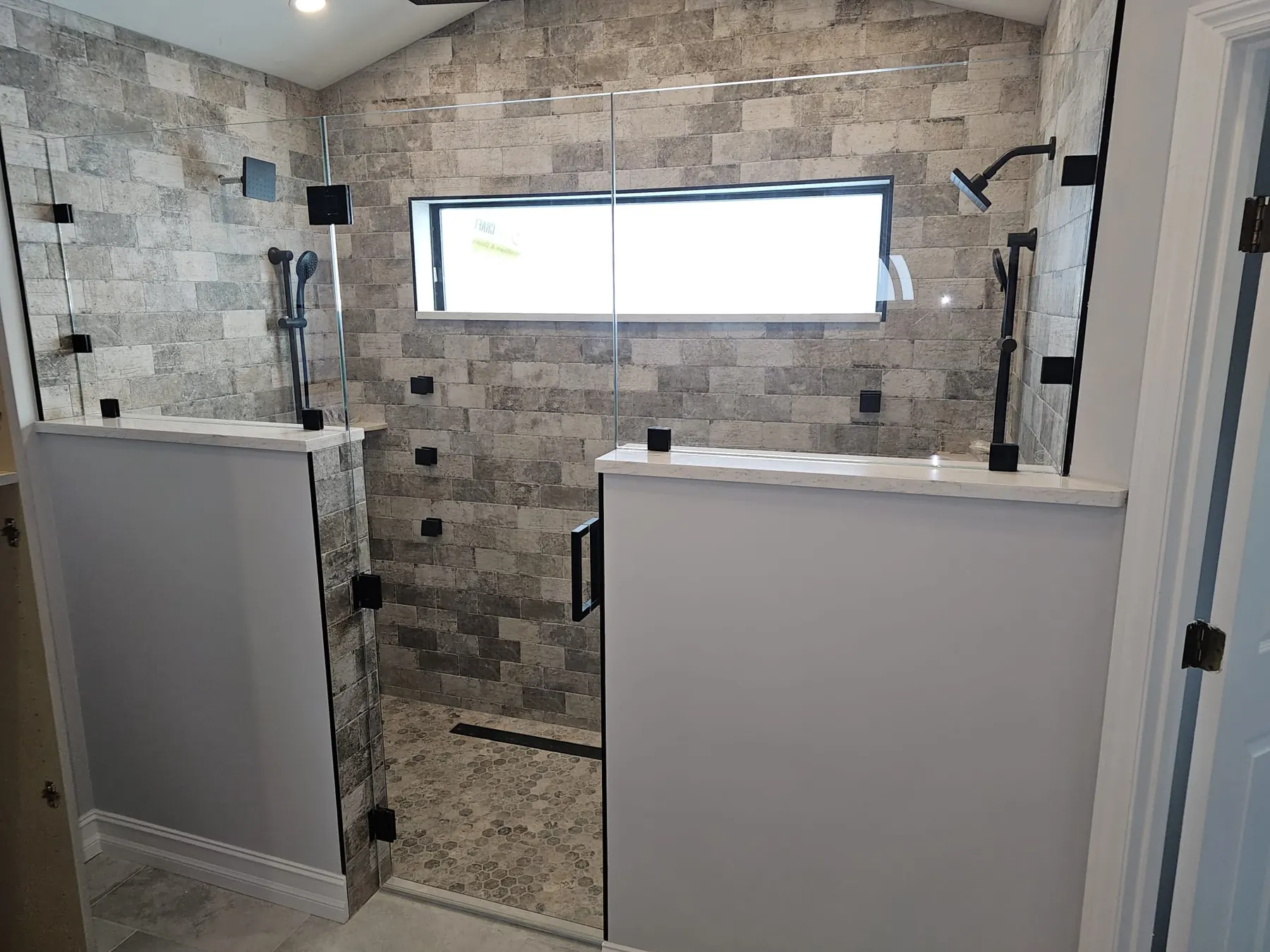 after frameless shower glass with black hardware in Southwest Florida