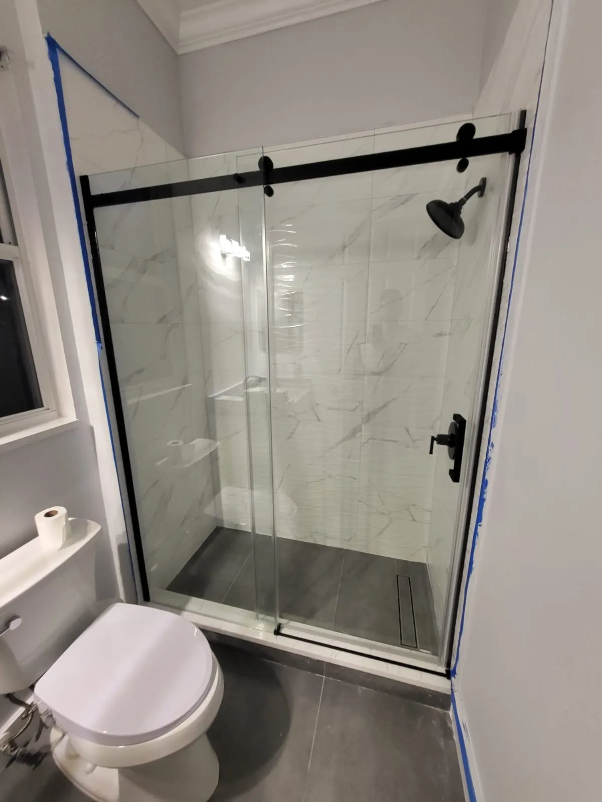 after frameless sliding shower glass with black hardware in Southwest Florida