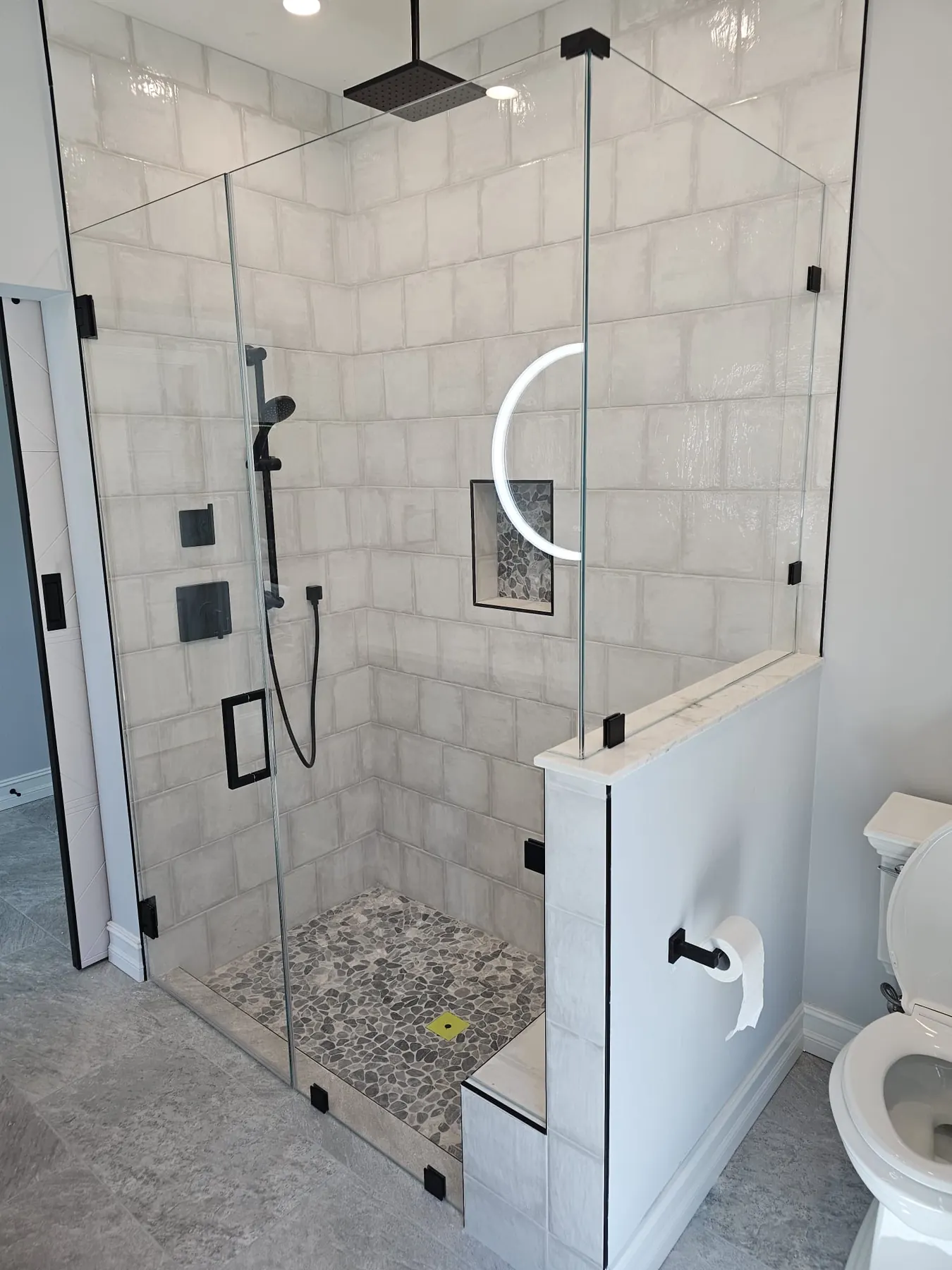 after frameless swing shower glass with black hardware in Southwest Florida