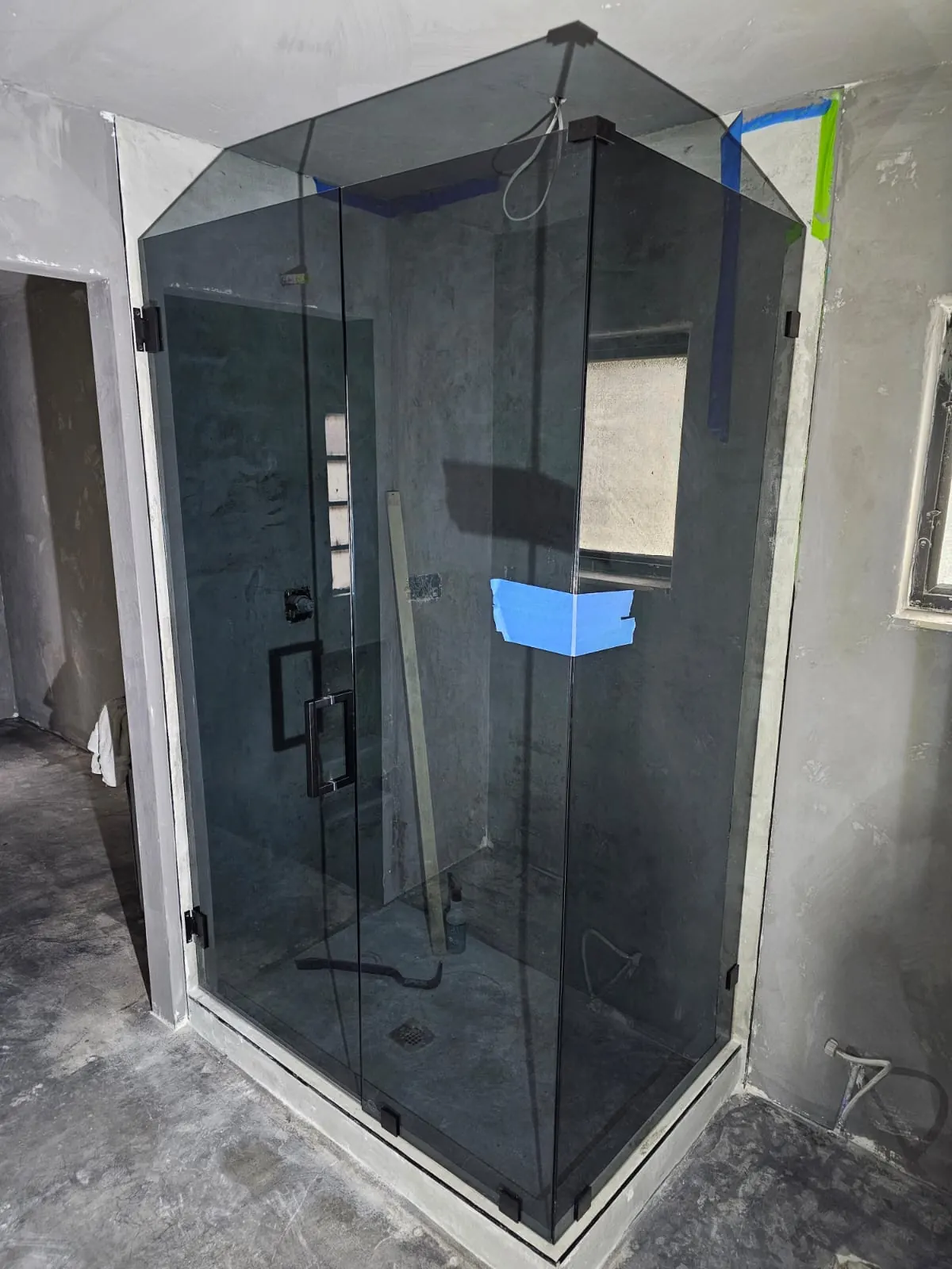 after frameless swing shower glass with black hardware in Southwest Florida