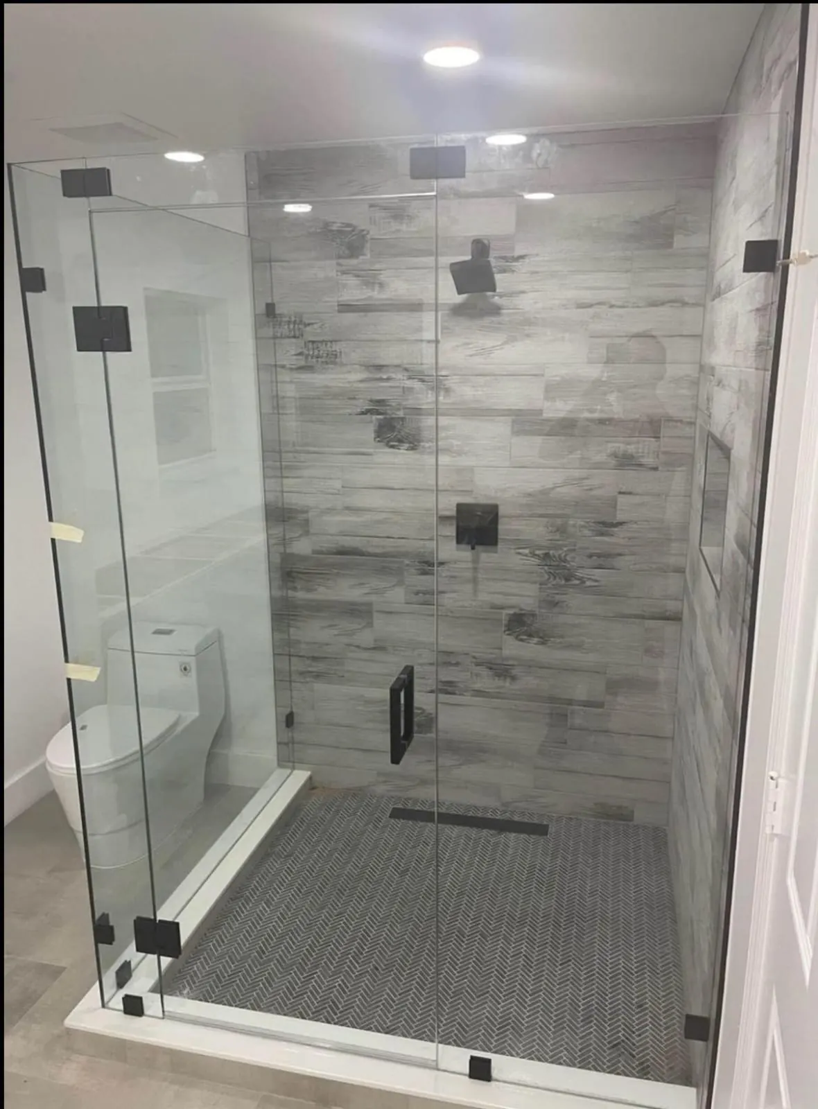 after frameless swing shower glass with black hardware in Southwest Florida