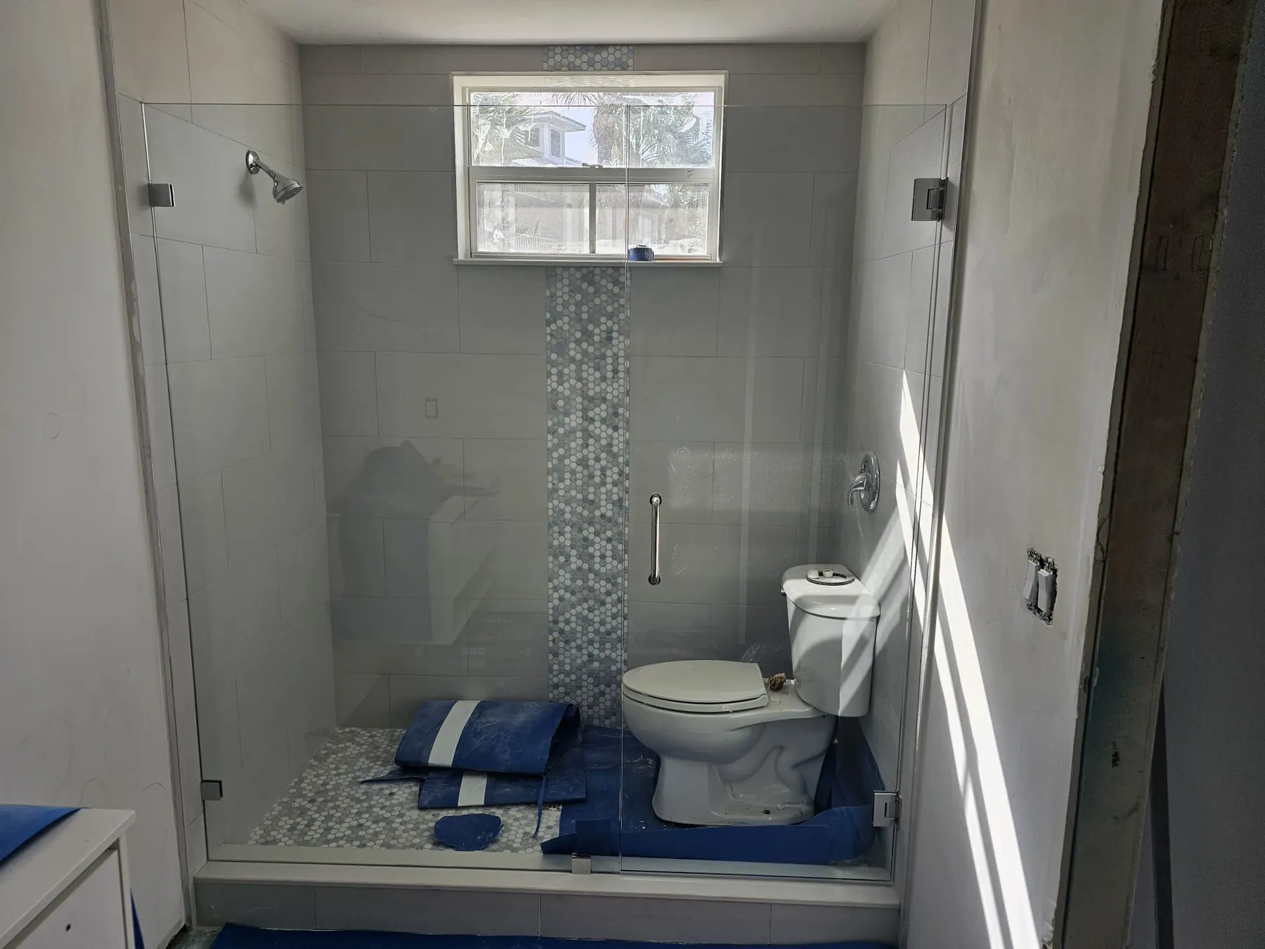 after frameless swing shower glass with chrome hardware in Southwest Florida