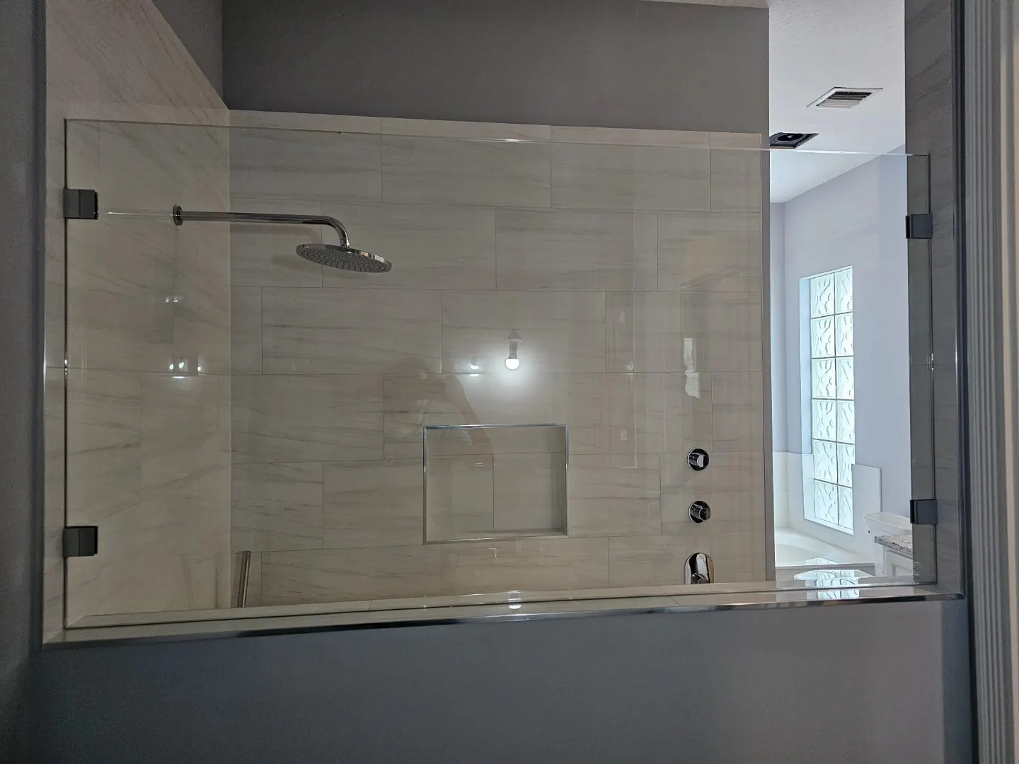 after frameless shower glass with chrome hardware in Southwest Florida