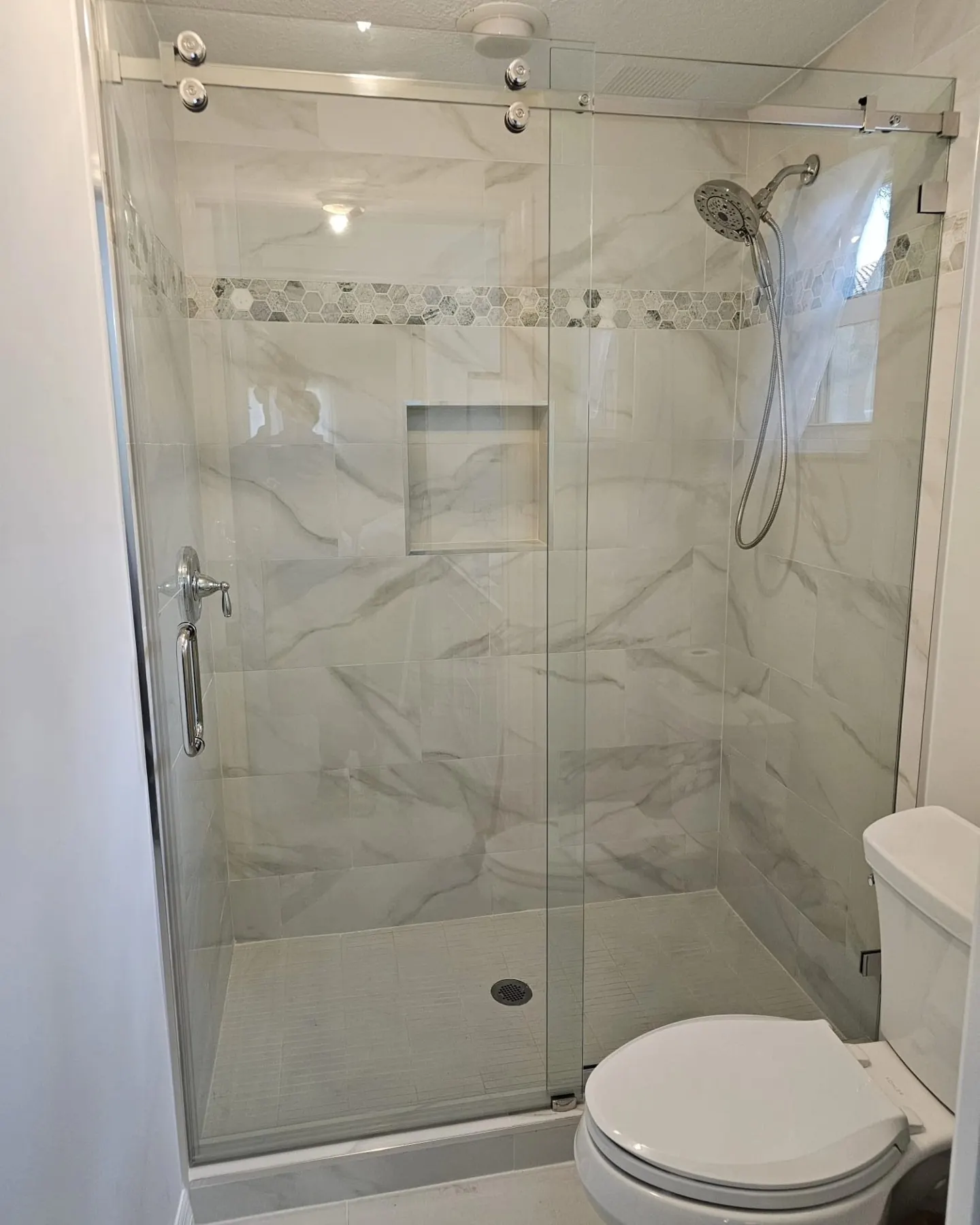 after frameless sliding shower glass with chrome hardware in Southwest Florida