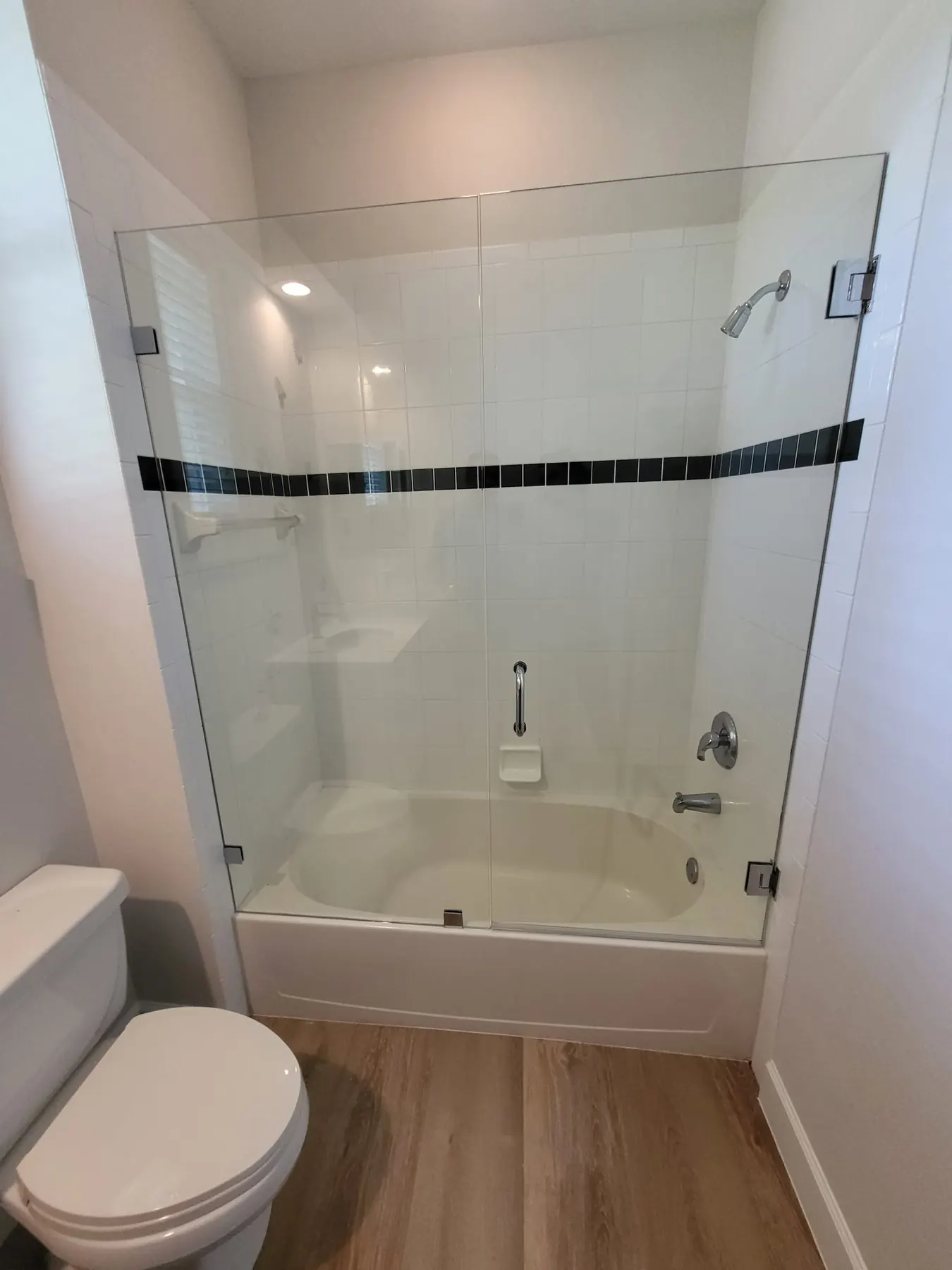 after frameless swing shower glass with chrome hardware in Southwest Florida