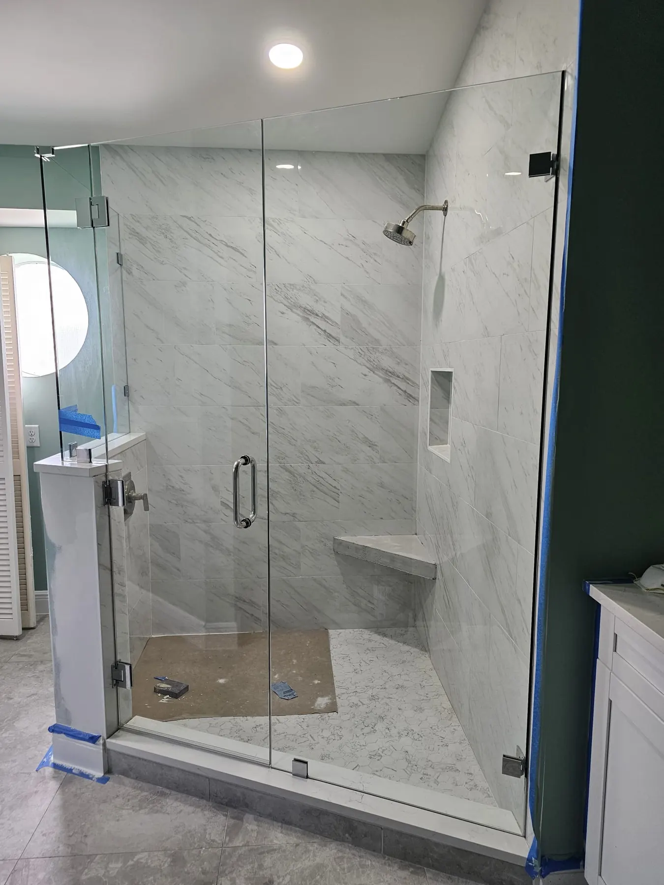 after frameless swing shower glass with chrome hardware in Southwest Florida