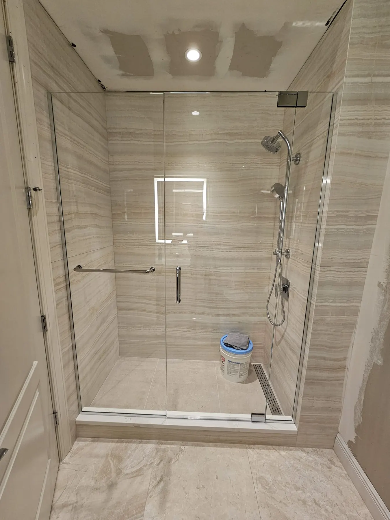 after frameless swing shower glass with chrome hardware in Southwest Florida
