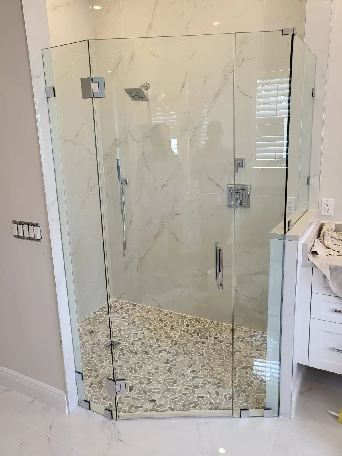 after frameless swing shower glass with chrome hardware in Southwest Florida