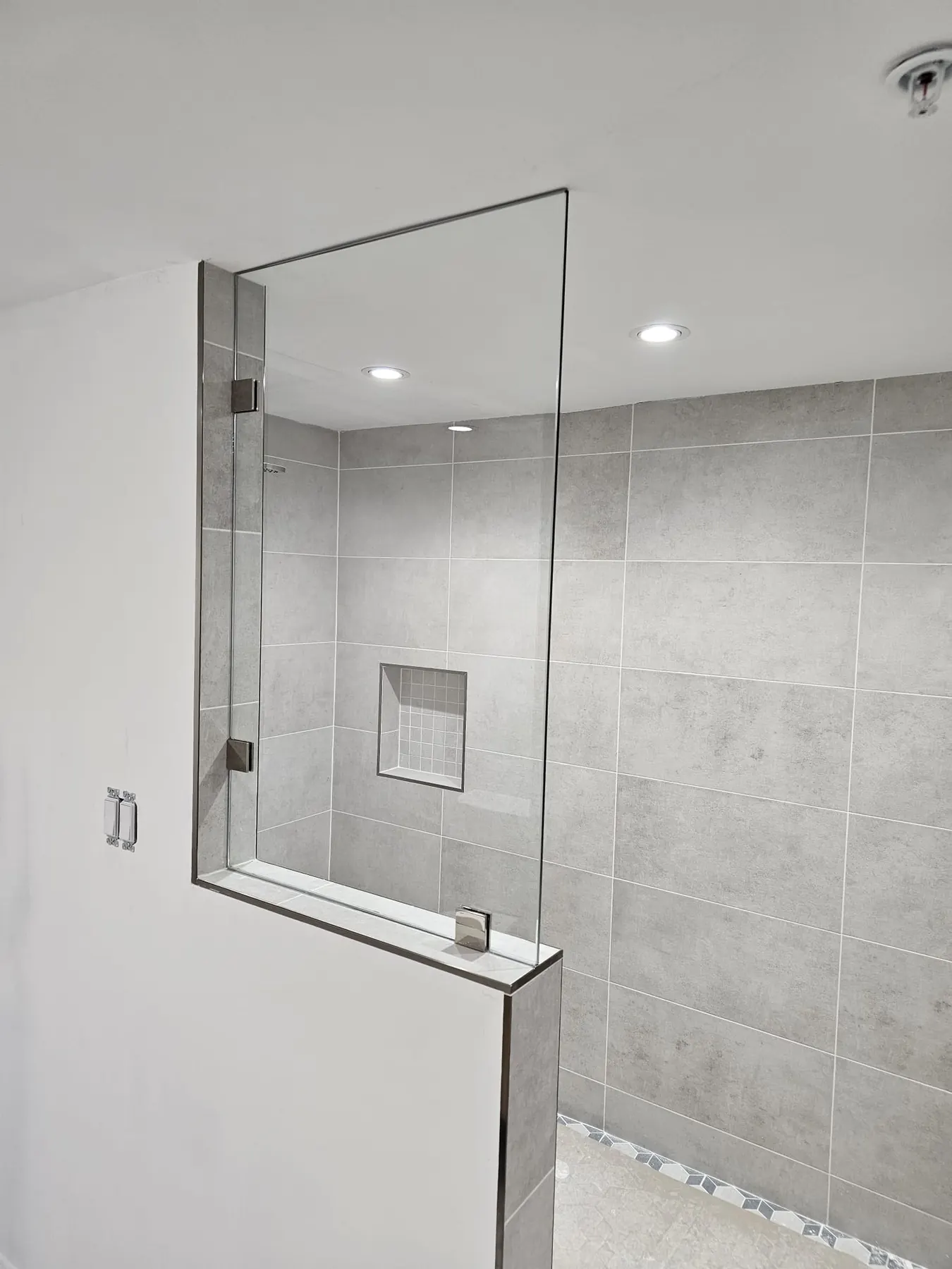after frameless shower glass with chrome hardware in Southwest Florida