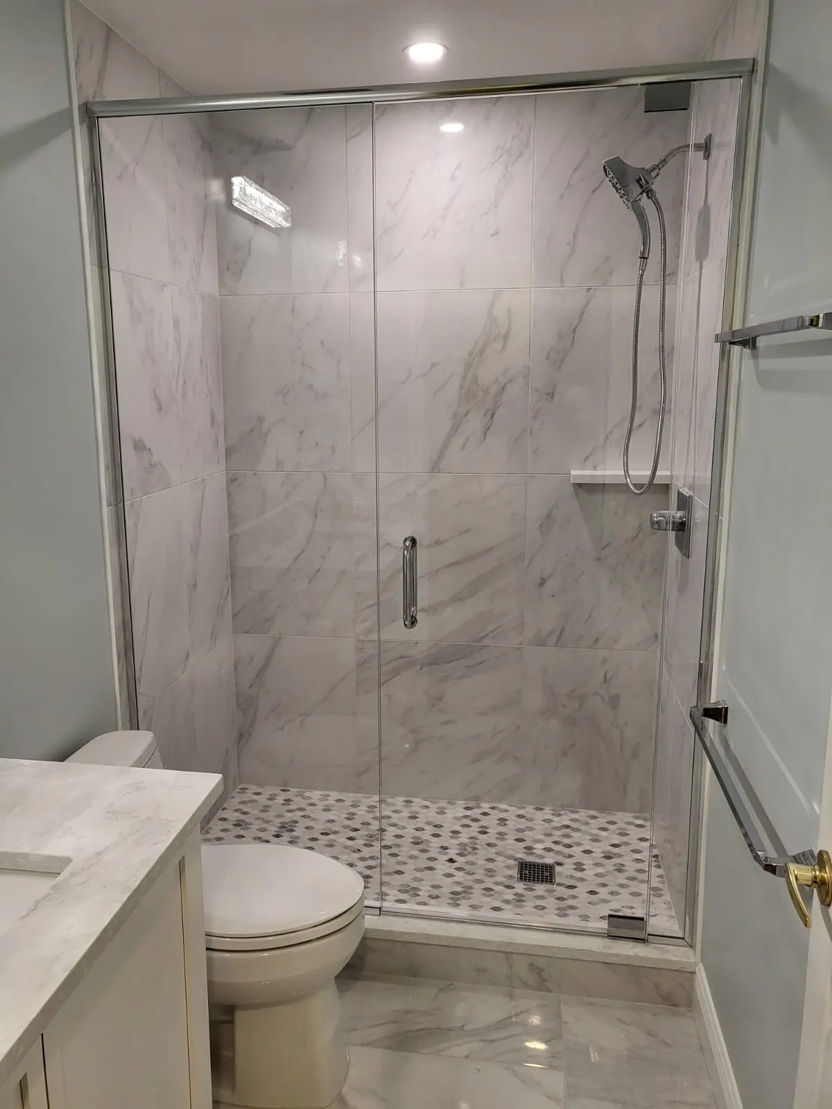 after frameless swing shower glass with chrome hardware in Southwest Florida