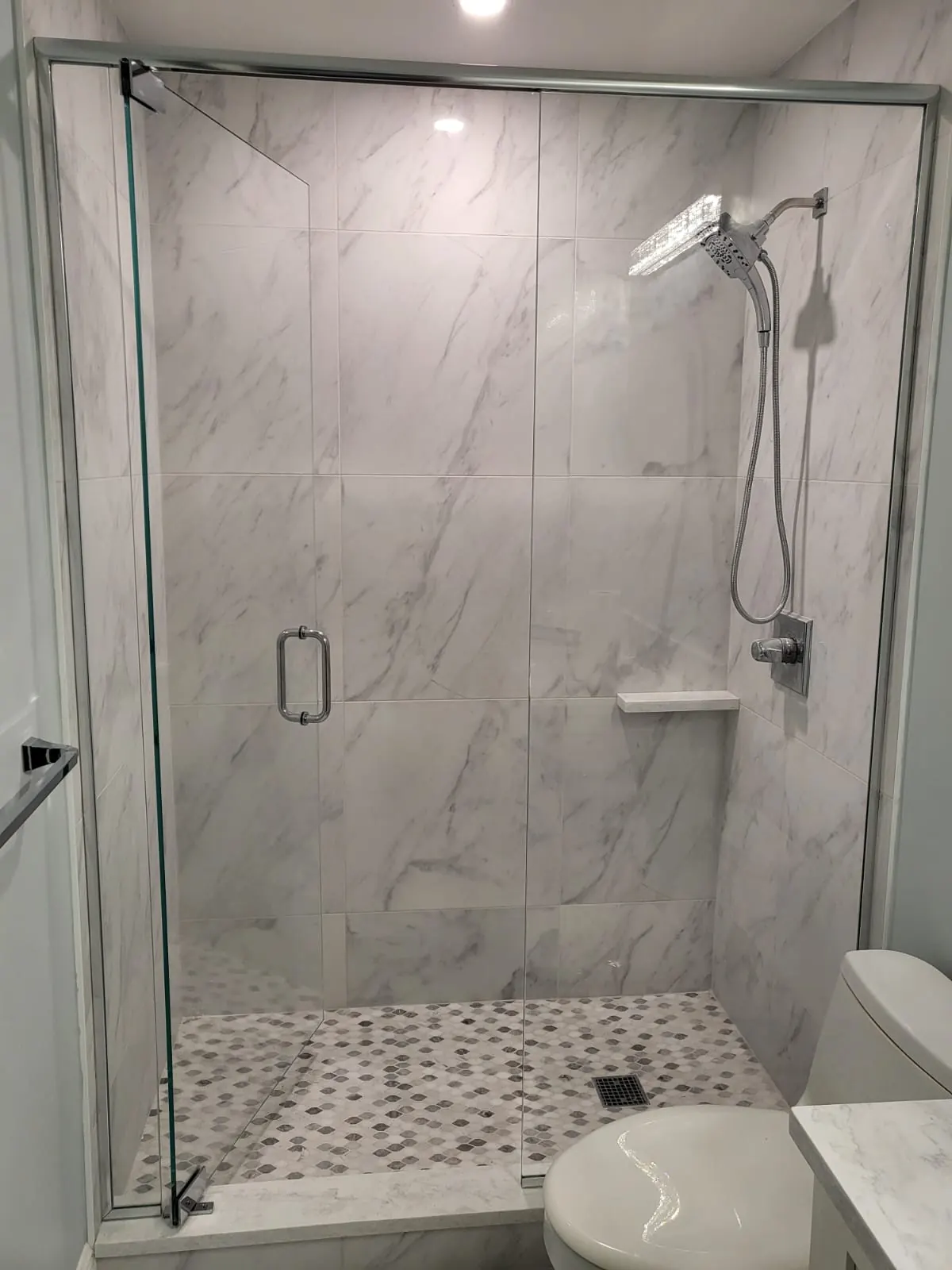 after frameless swing shower glass with chrome hardware in Southwest Florida