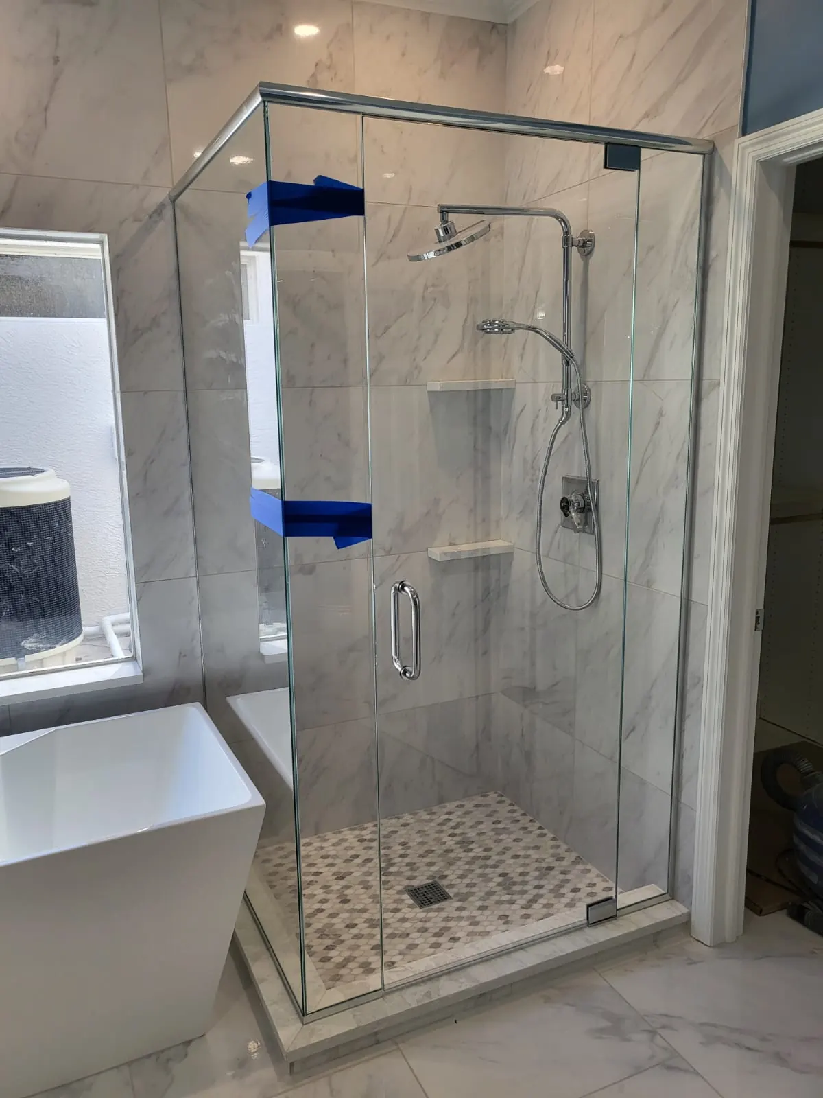 after frameless swing shower glass with chrome hardware in Southwest Florida