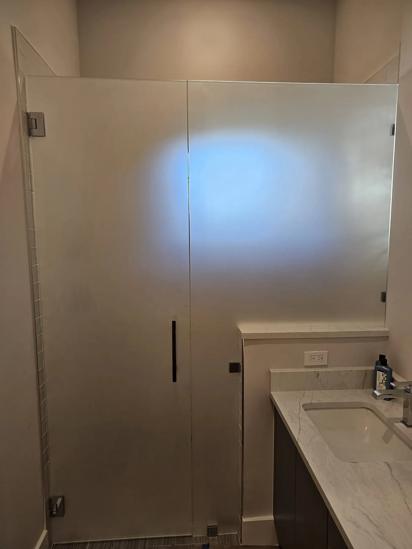 after frameless swing shower glass with chrome hardware in Southwest Florida