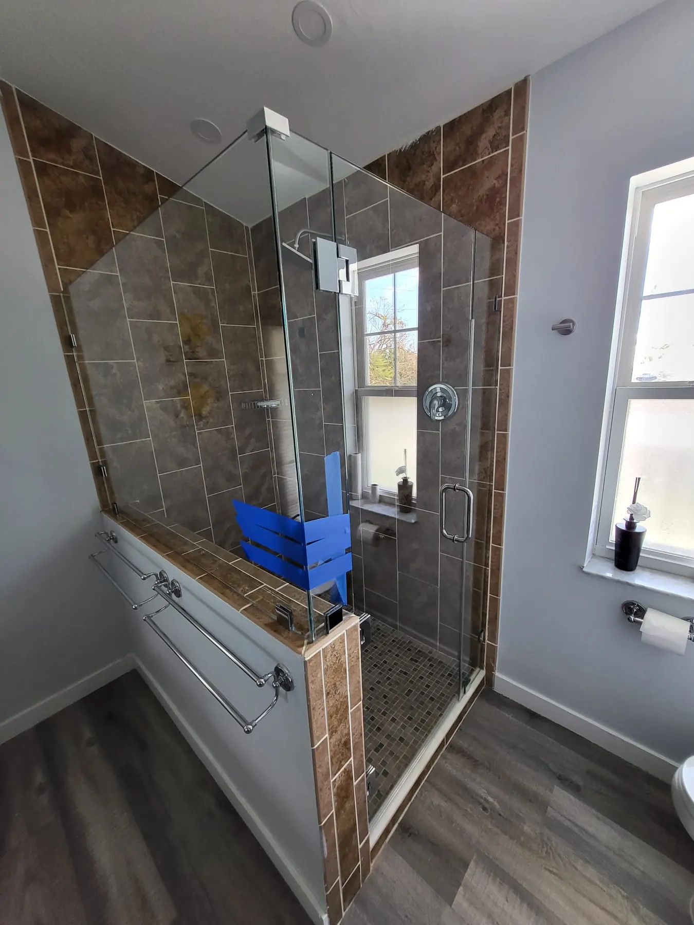 after frameless swing shower glass with chrome hardware in Southwest Florida
