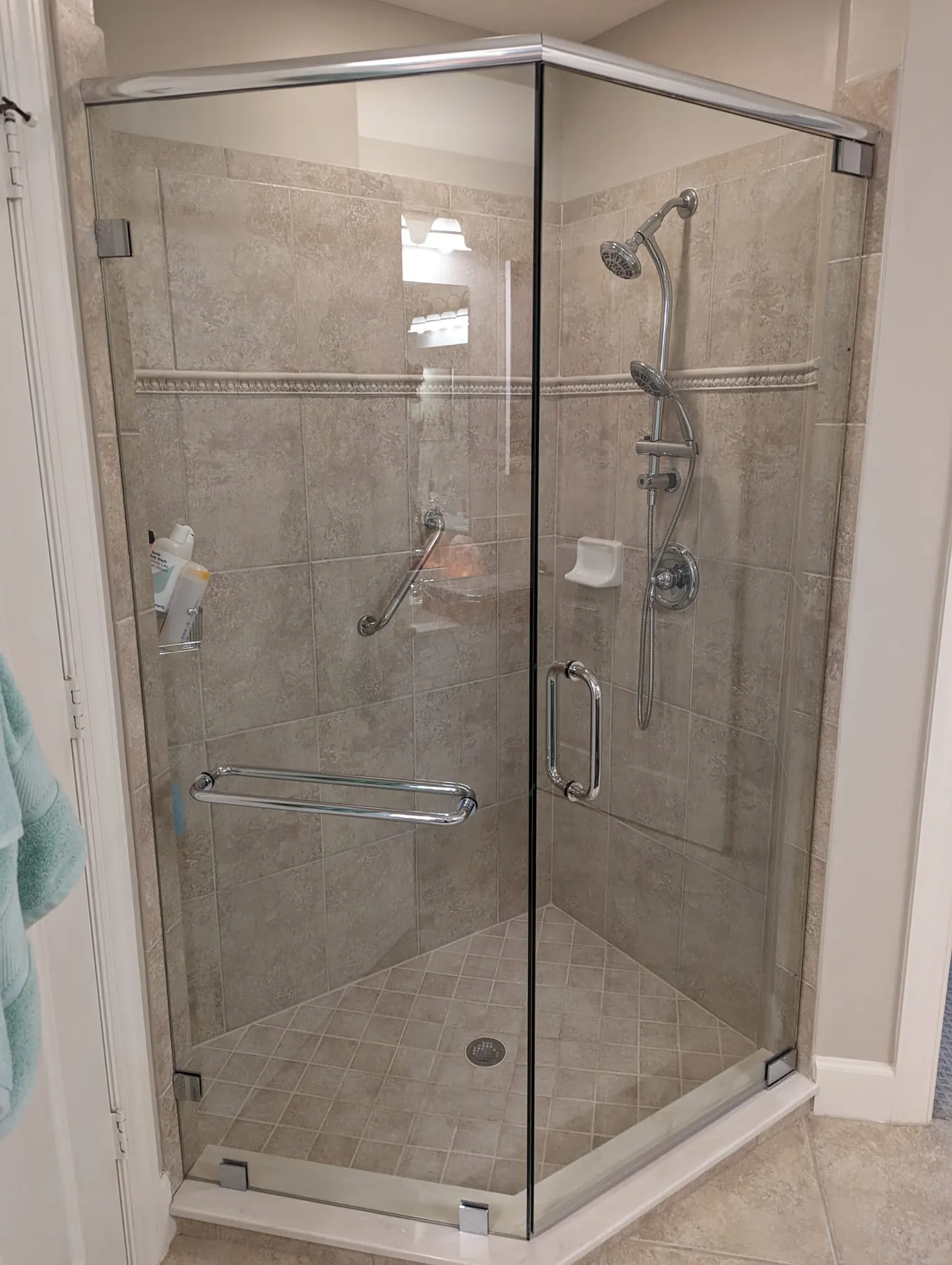 after frameless swing shower glass with chrome hardware in Southwest Florida
