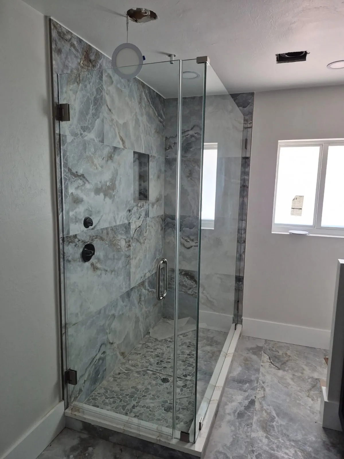 after frameless swing shower glass with chrome hardware in Southwest Florida
