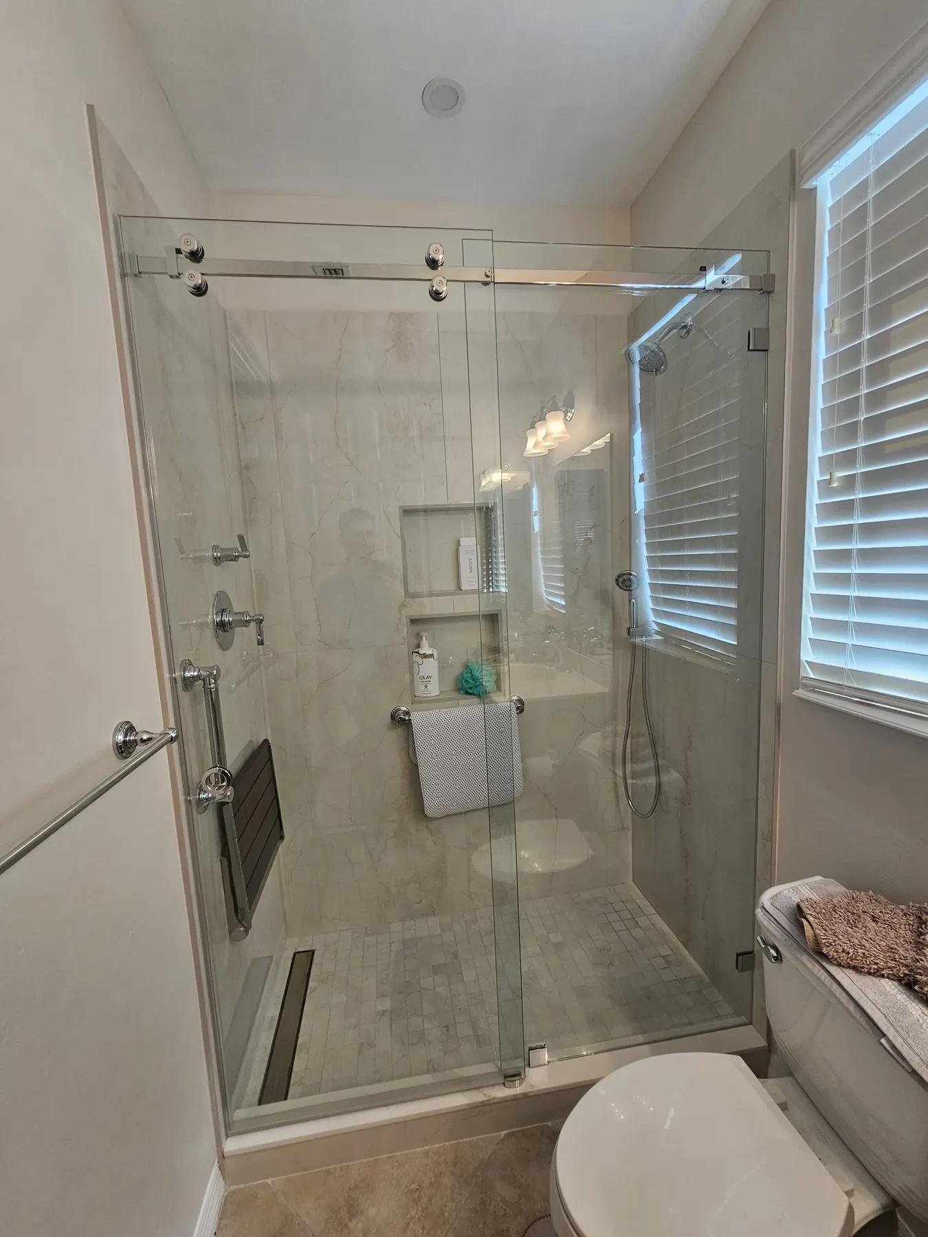 after frameless sliding shower glass with chrome hardware in Southwest Florida