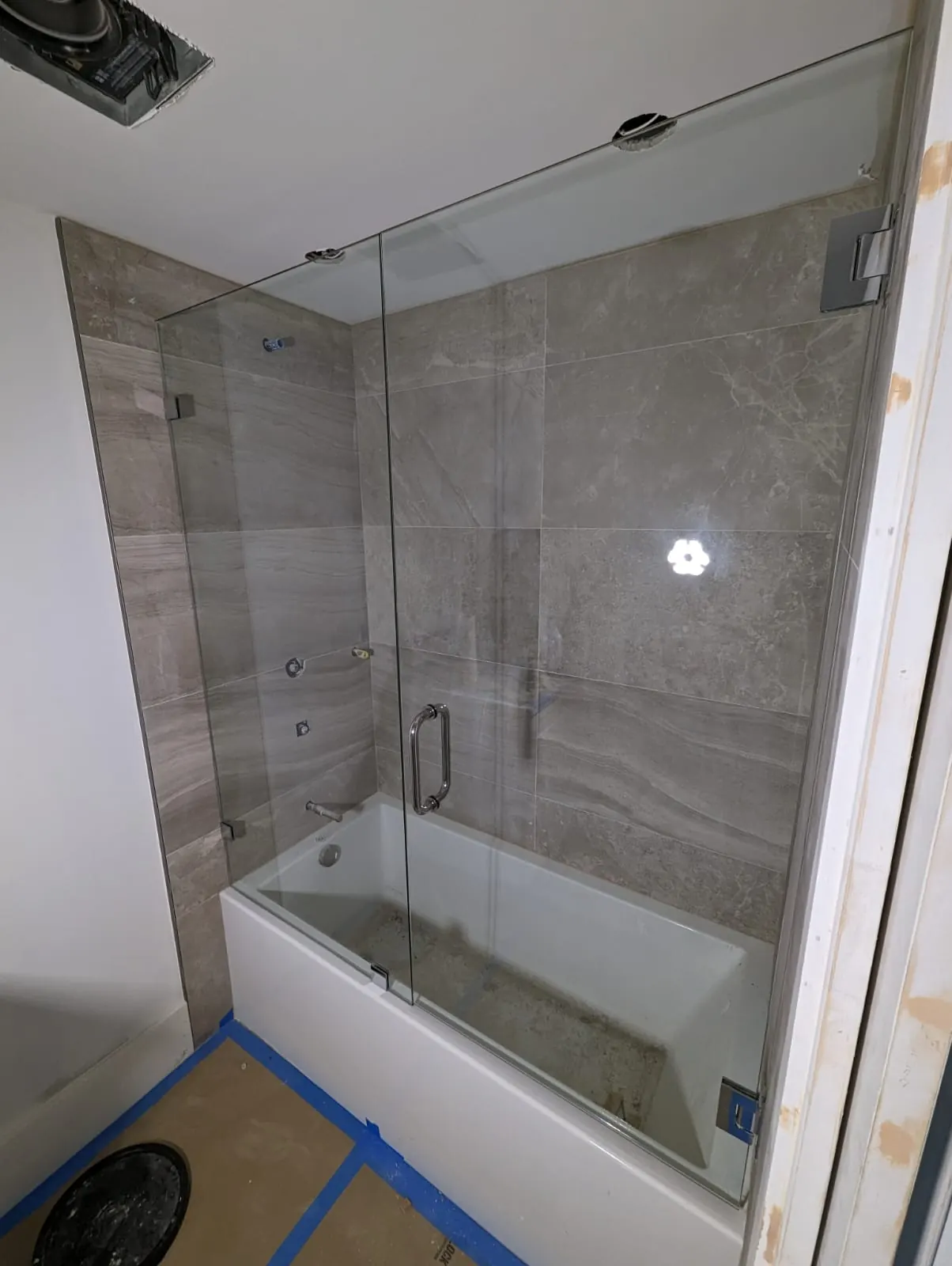 after frameless swing shower glass with chrome hardware in Southwest Florida