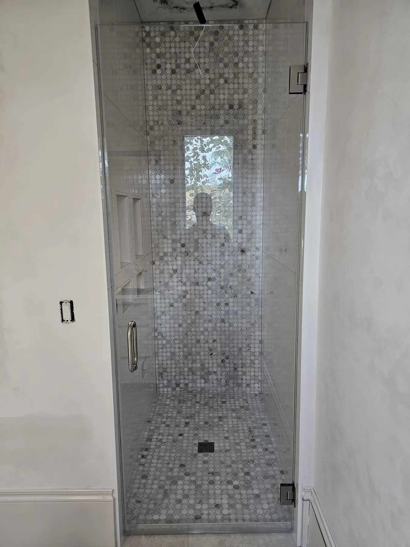 after frameless swing shower glass with chrome hardware in Southwest Florida