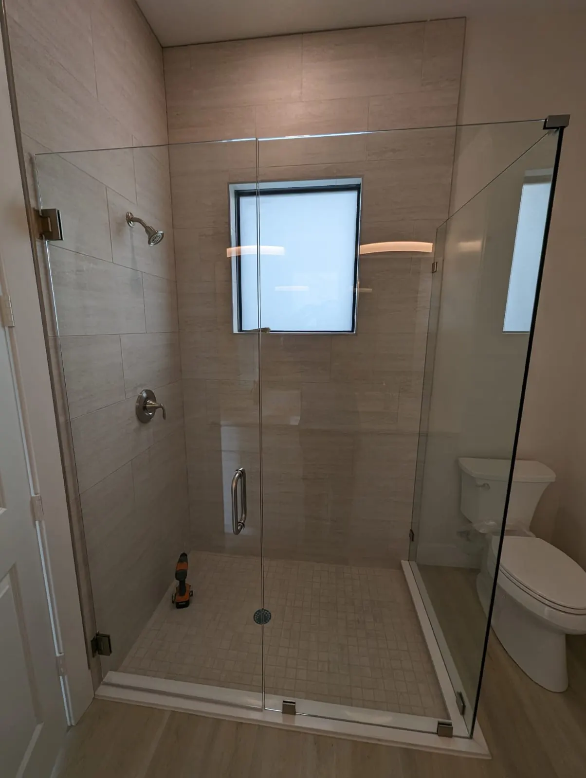 after frameless swing shower glass with chrome hardware in Southwest Florida