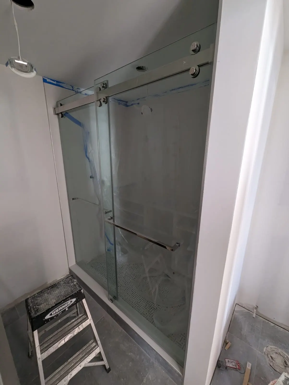 after frameless sliding shower glass with chrome hardware in Southwest Florida