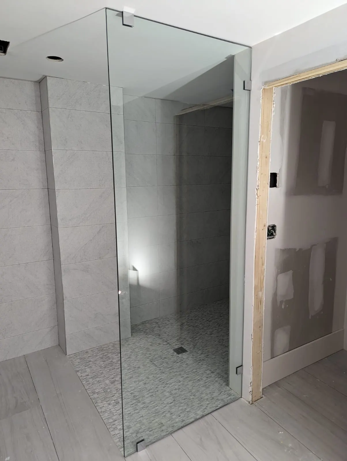 after frameless shower glass with chrome hardware in Southwest Florida