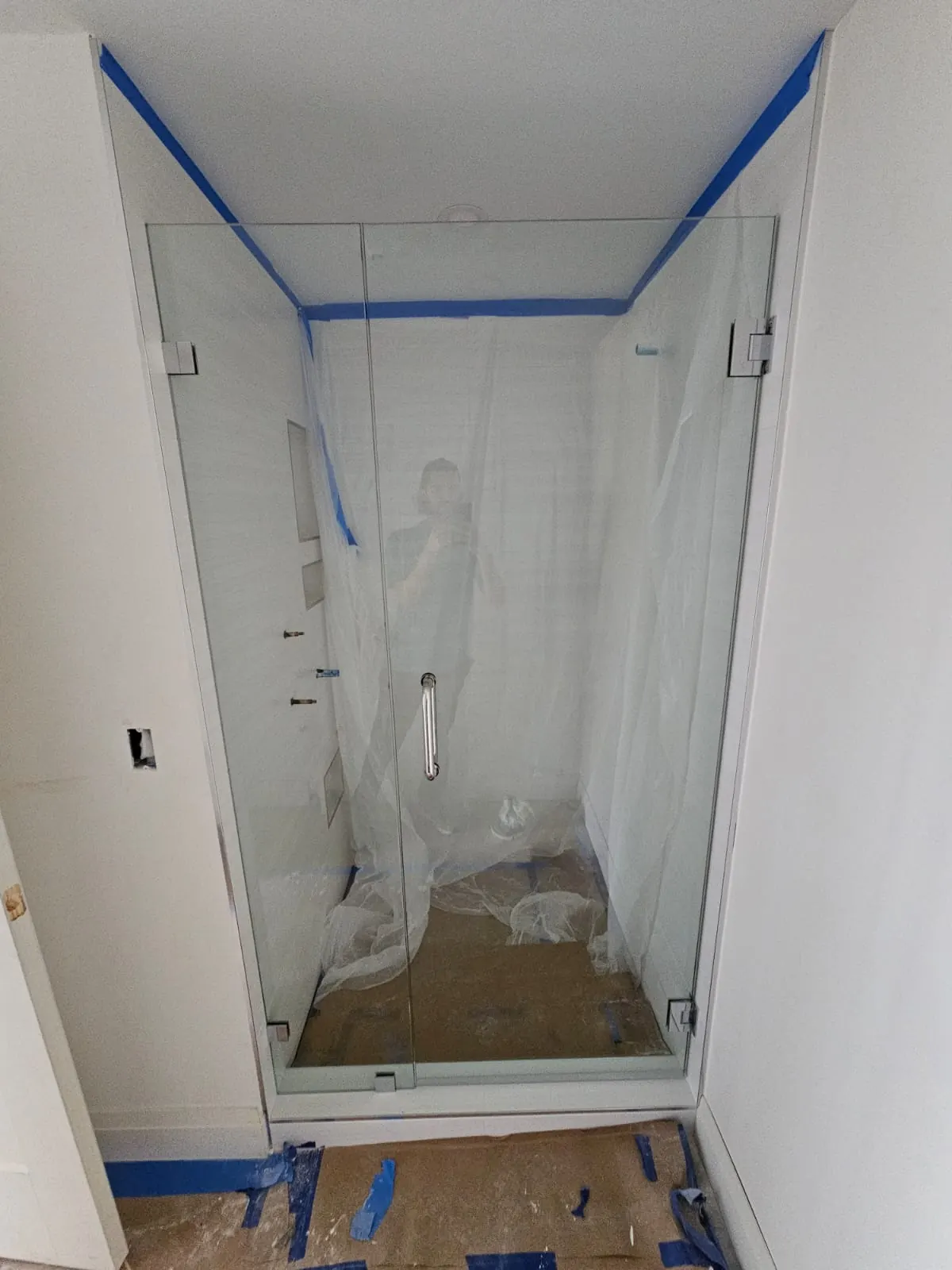 after frameless swing shower glass with chrome hardware in Southwest Florida