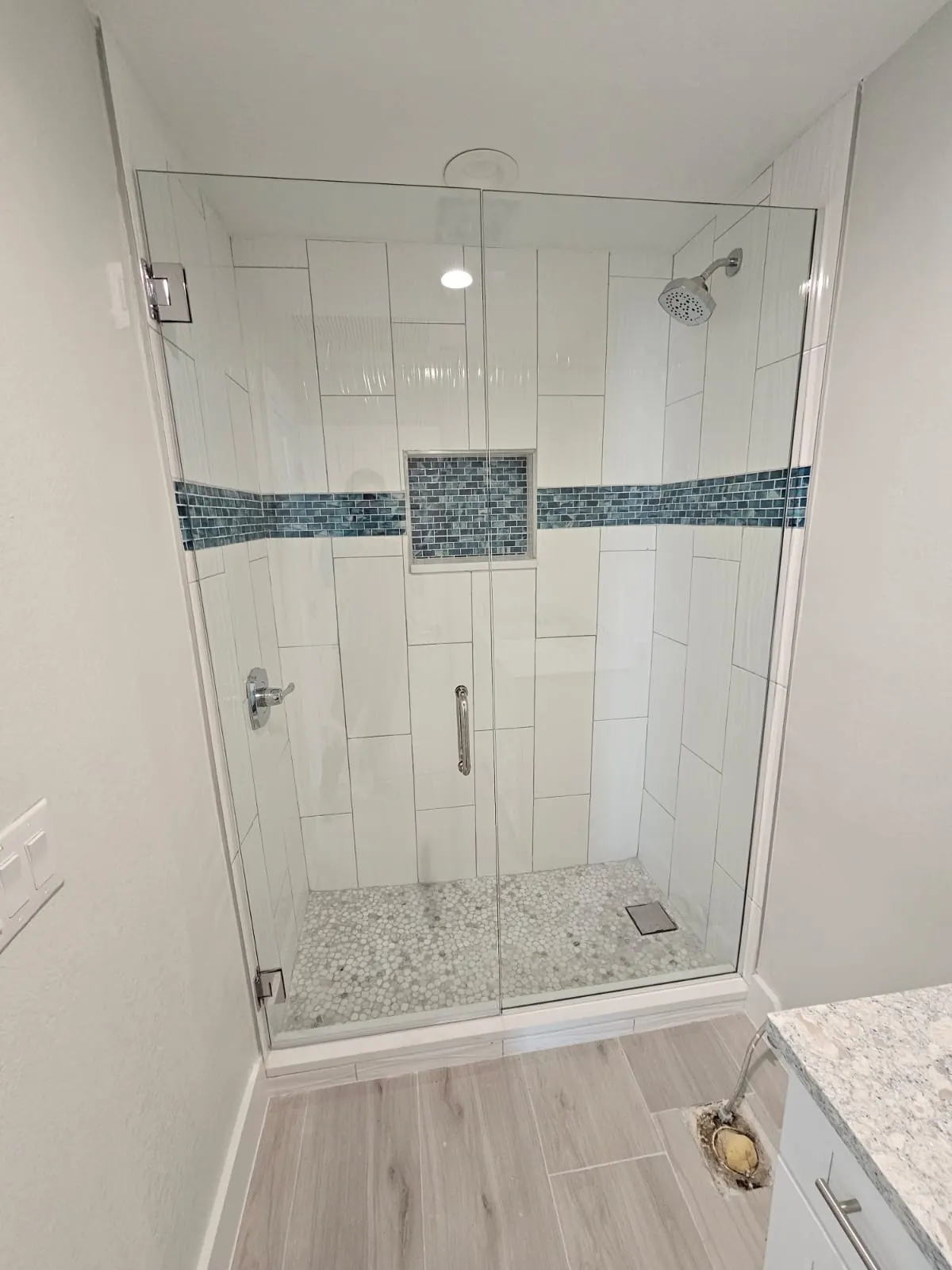after frameless swing shower glass with chrome hardware in Southwest Florida