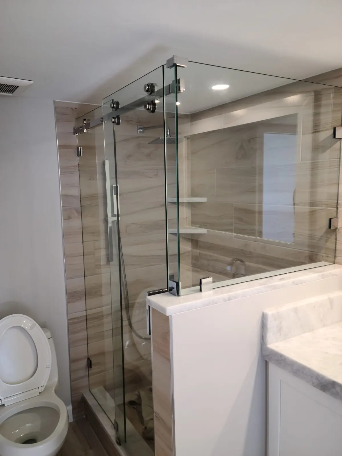 after frameless sliding shower glass with chrome hardware in Southwest Florida