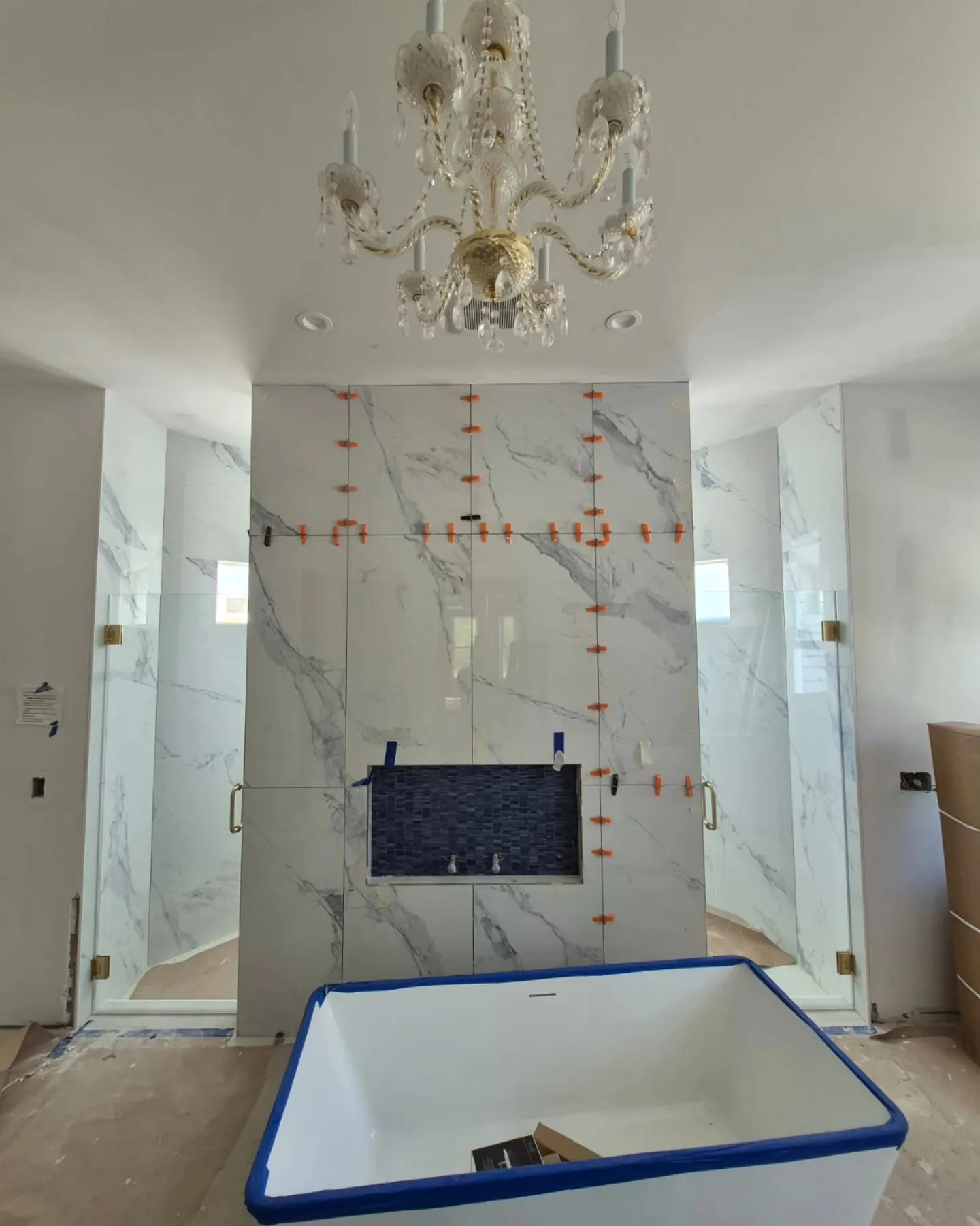 after frameless swing shower glass with brushed gold hardware in Southwest Florida