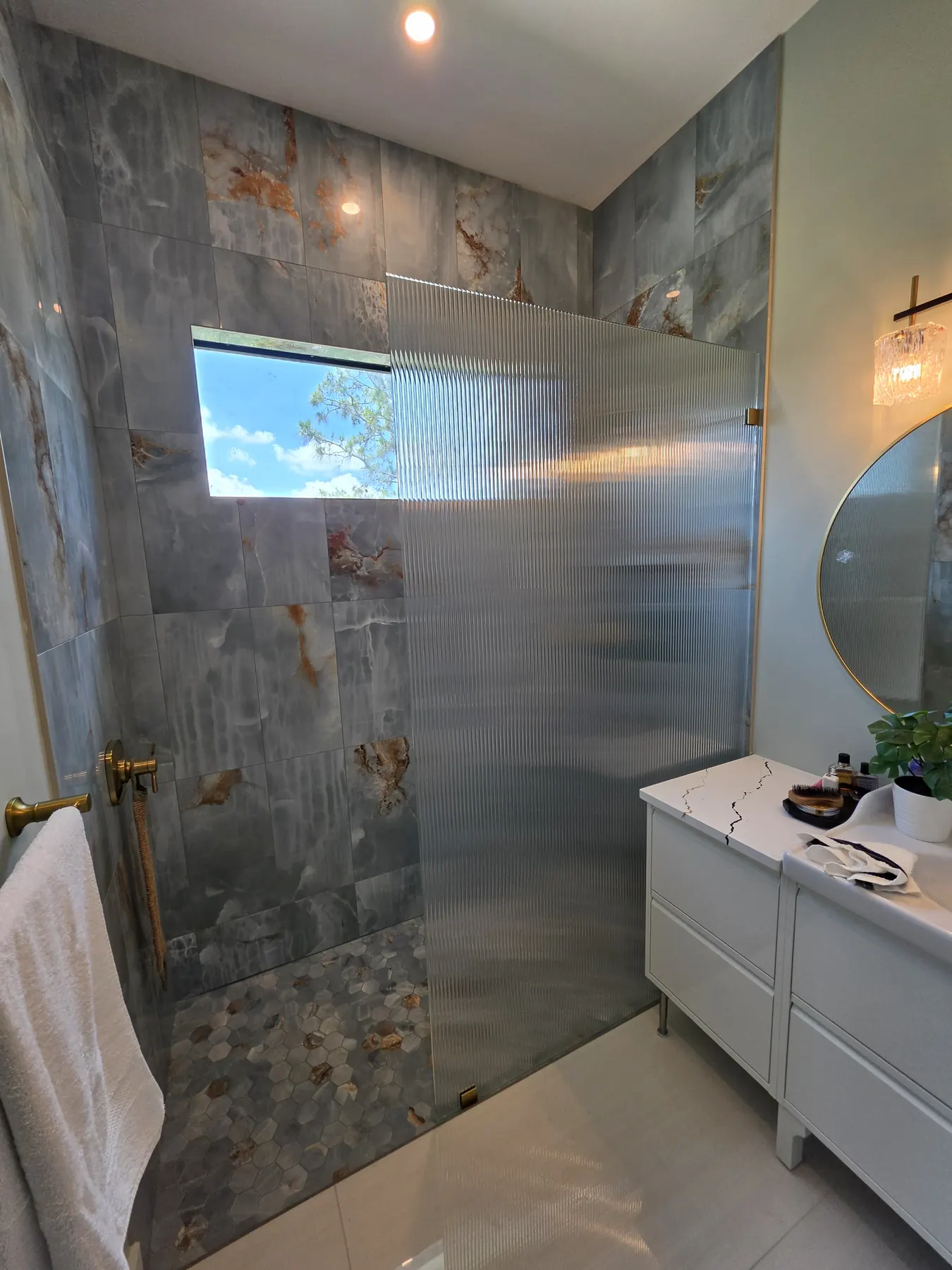 after frameless shower glass with brushed gold hardware in Southwest Florida