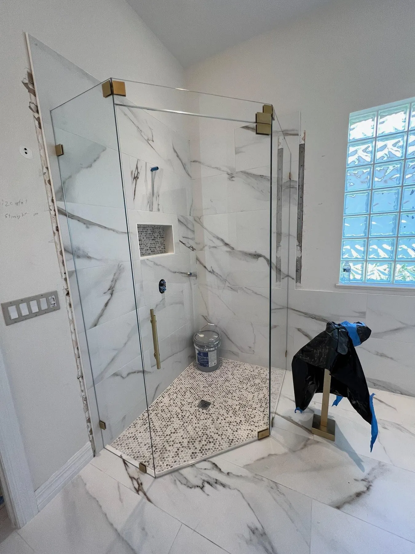 after frameless swing shower glass with brushed gold hardware in Southwest Florida