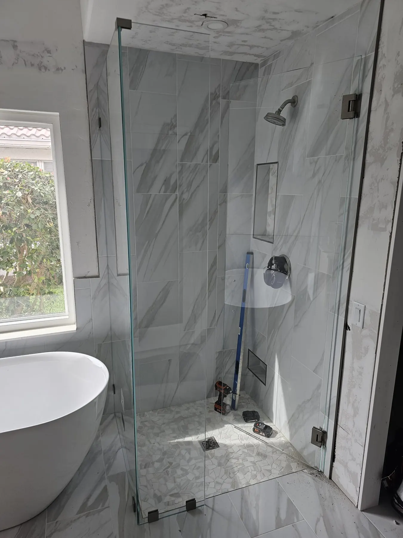 after frameless swing shower glass with brushed nickel hardware in Southwest Florida