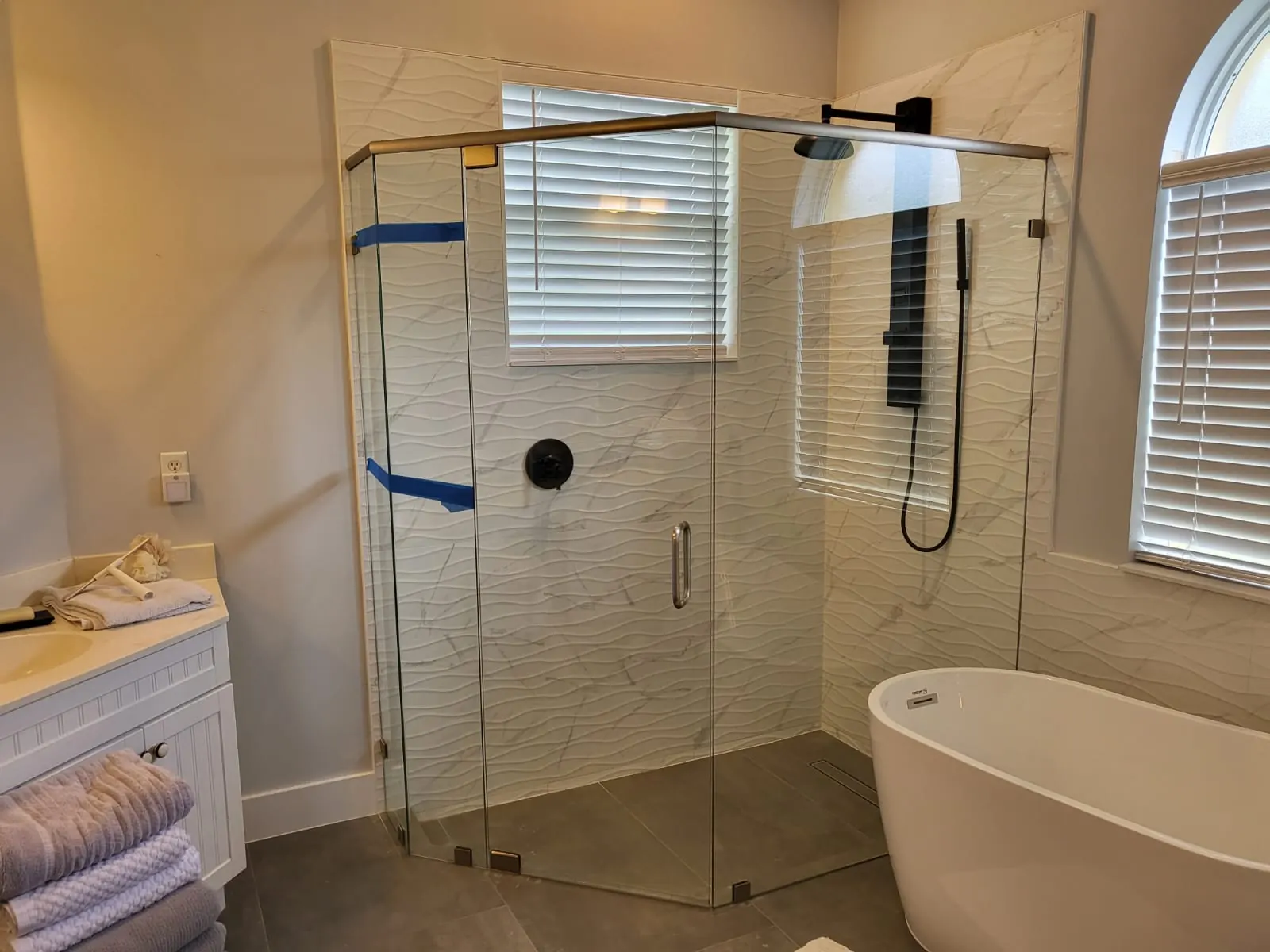 after frameless swing shower glass with brushed nickel hardware in Southwest Florida