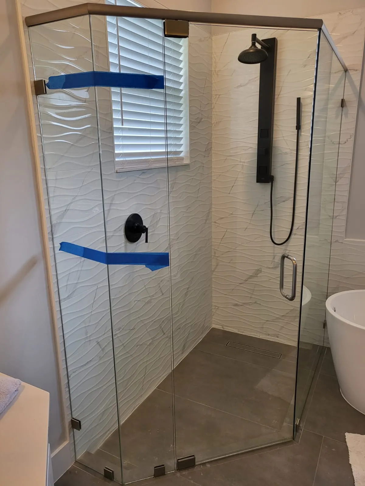 after frameless swing shower glass with brushed nickel hardware in Southwest Florida