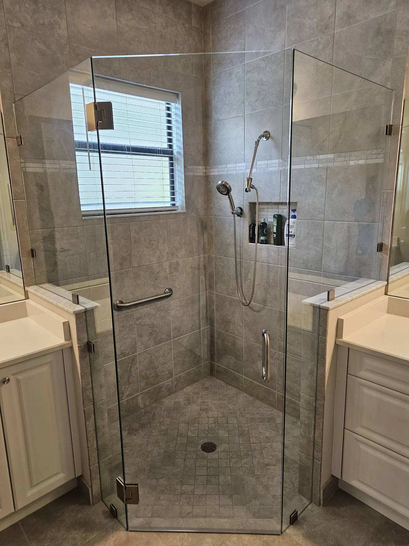after frameless swing shower glass with brushed nickel hardware in Southwest Florida