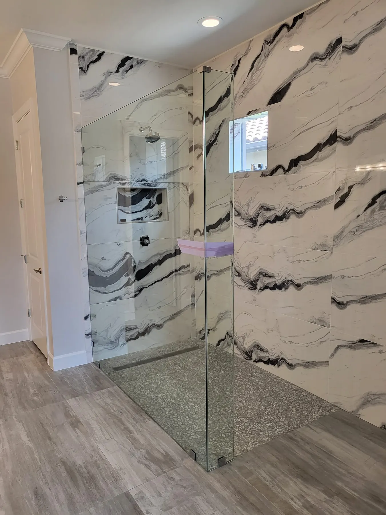 after frameless shower glass with brushed nickel hardware in Southwest Florida