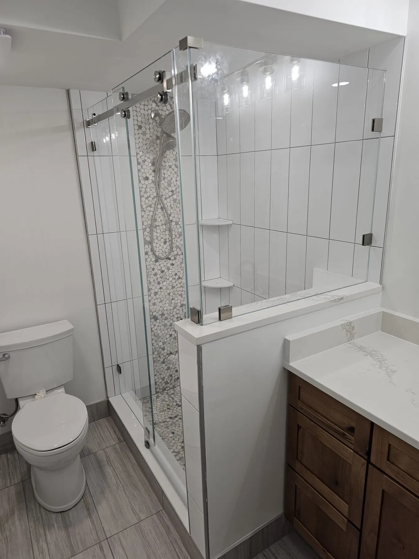 after frameless sliding shower glass with brushed nickel hardware in Southwest Florida