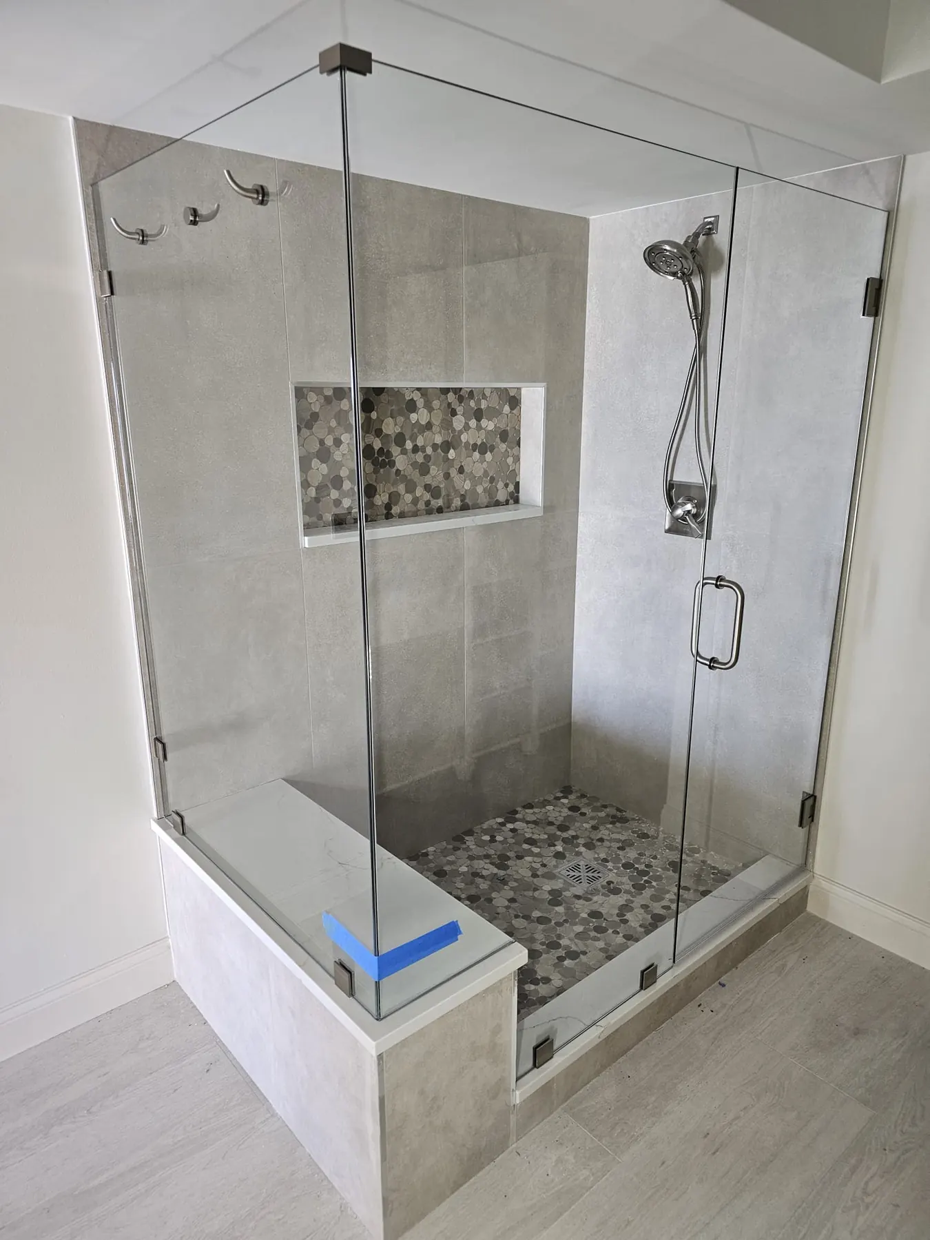 after frameless swing shower glass with brushed nickel hardware in Southwest Florida