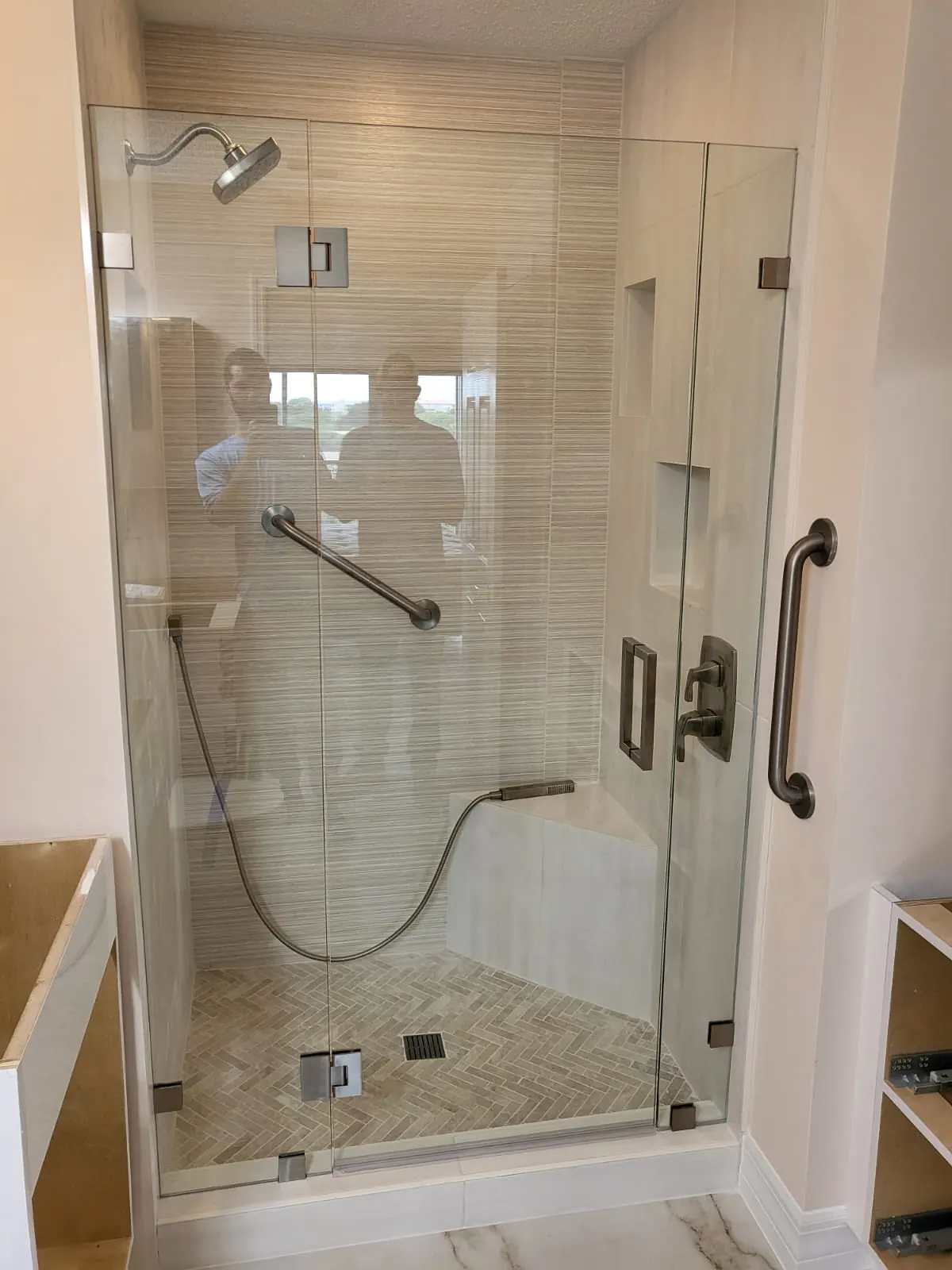 after frameless swing shower glass with brushed nickel hardware in Southwest Florida