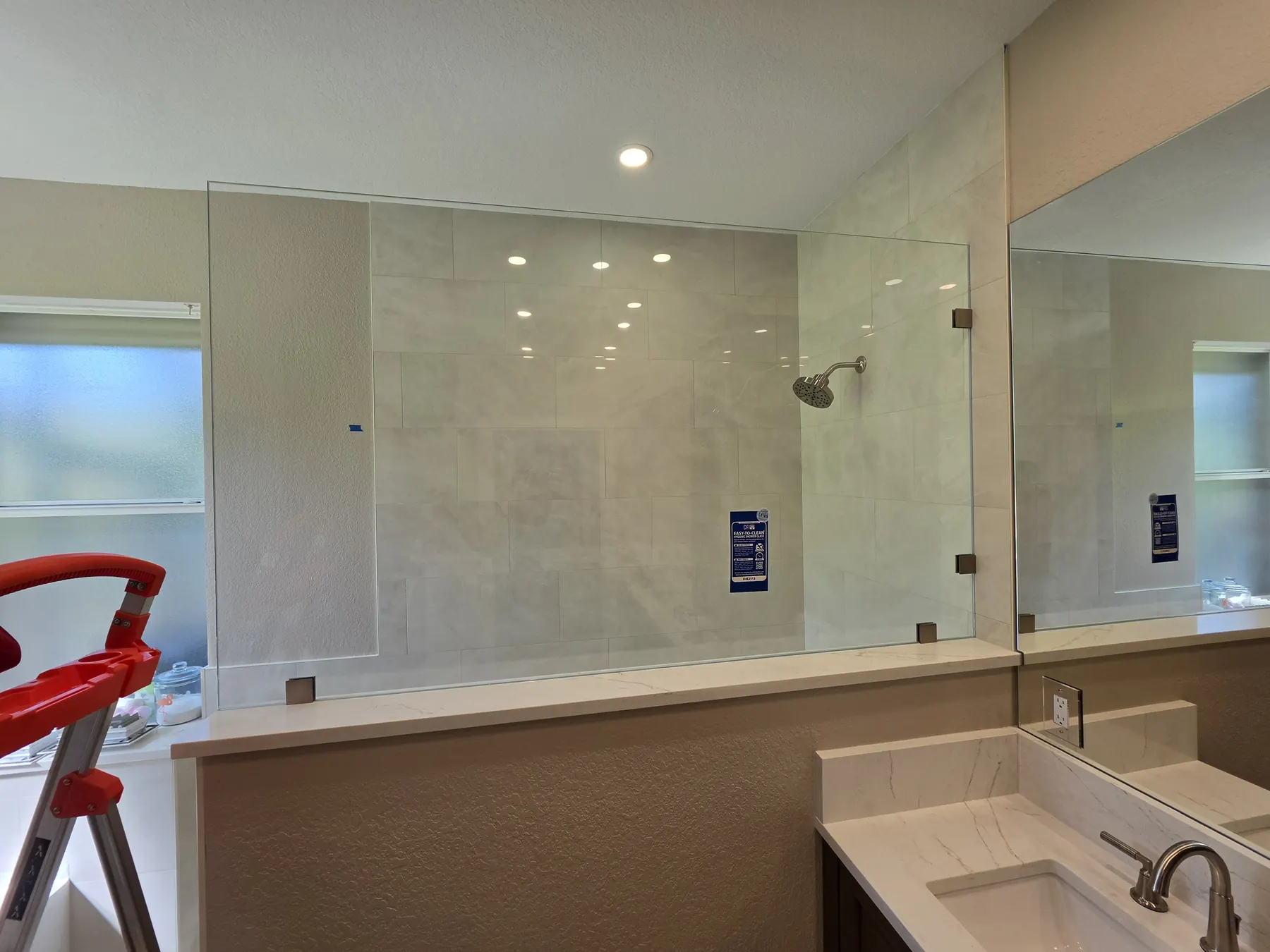 after frameless shower glass with brushed nickel hardware in Southwest Florida