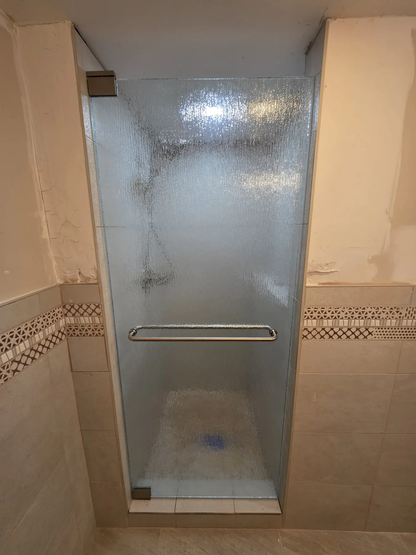 after frameless swing shower glass with brushed nickel hardware in Southwest Florida