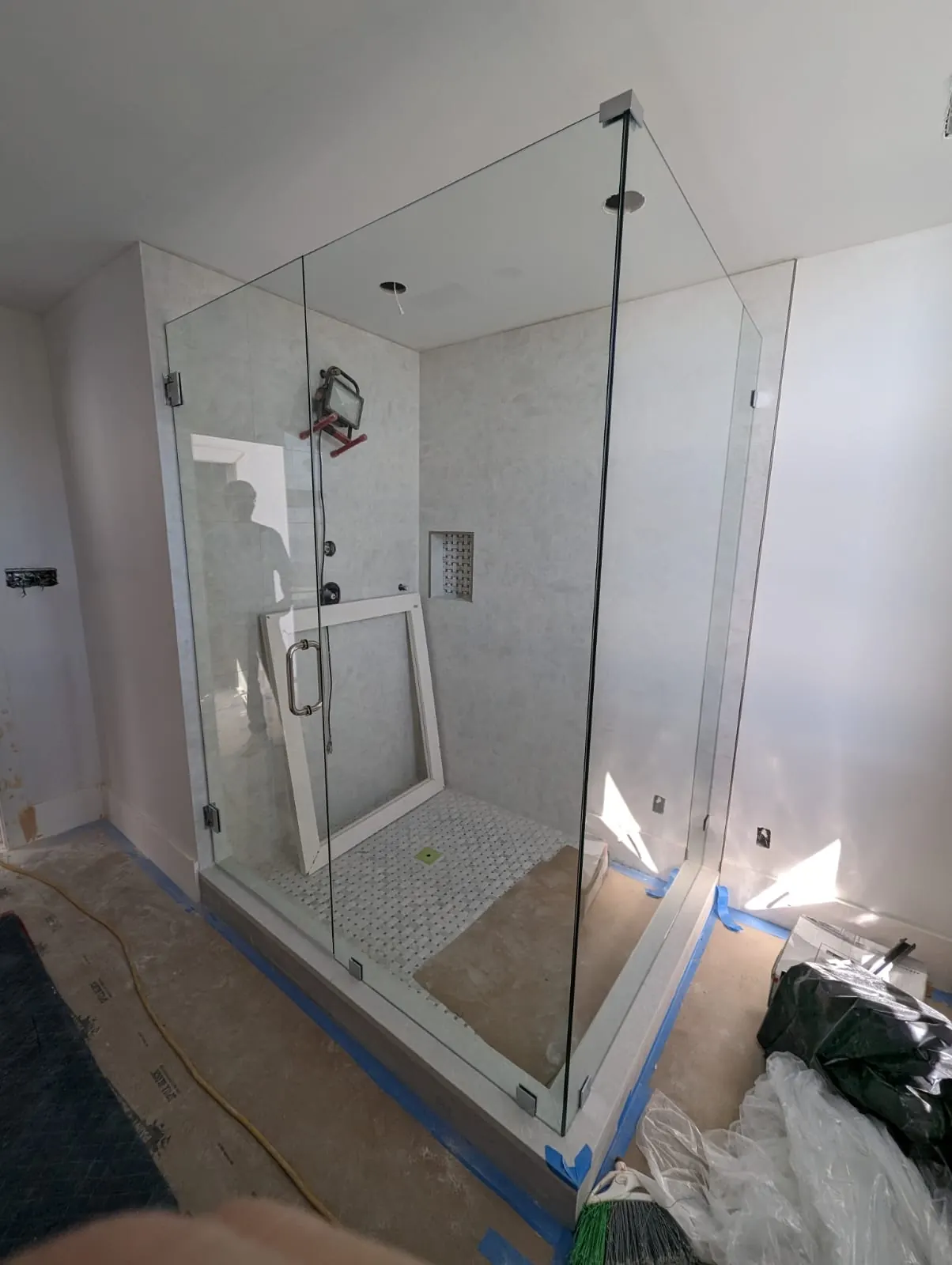 after frameless swing shower glass with brushed nickel hardware in Southwest Florida