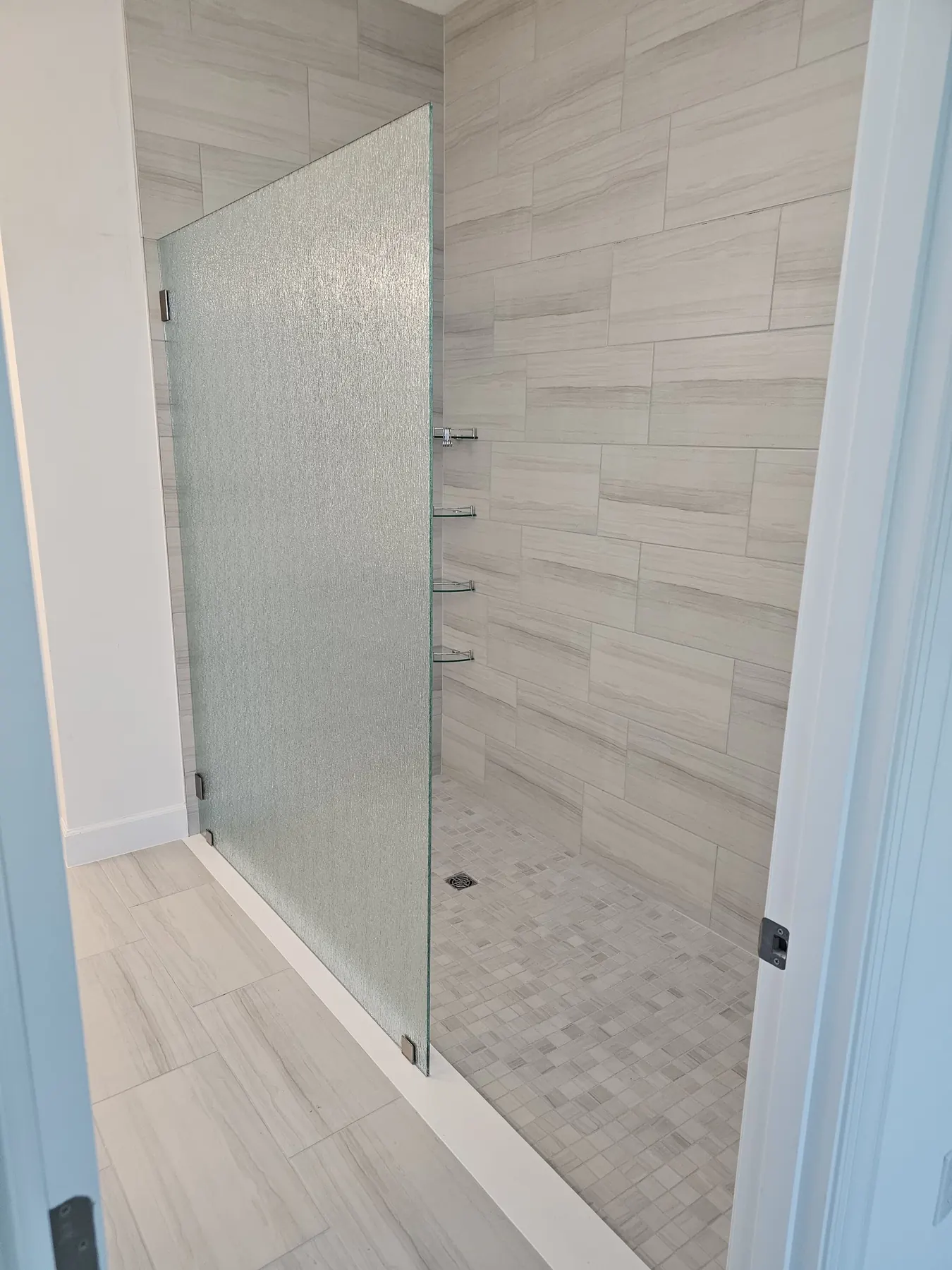 after frameless shower glass with brushed nickel hardware in Southwest Florida