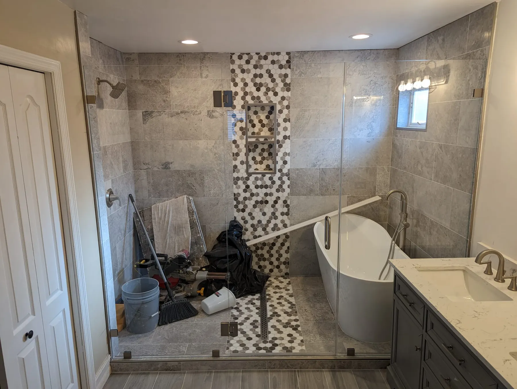 after frameless swing shower glass with brushed nickel hardware in Southwest Florida
